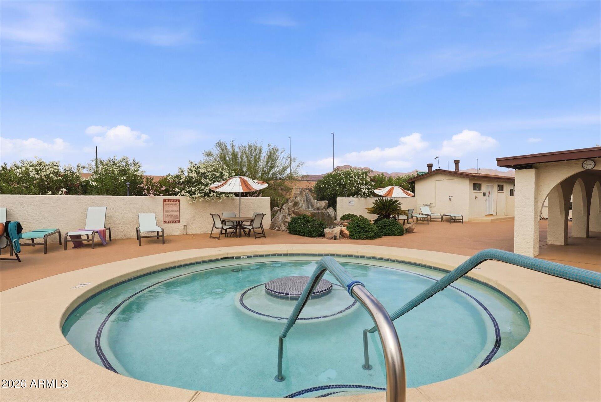 3270 South Goldfield Road, Unit 716 Apache Junction, AZ 85119 - Photo 31 of 36 a view of a swimming pool with a yard