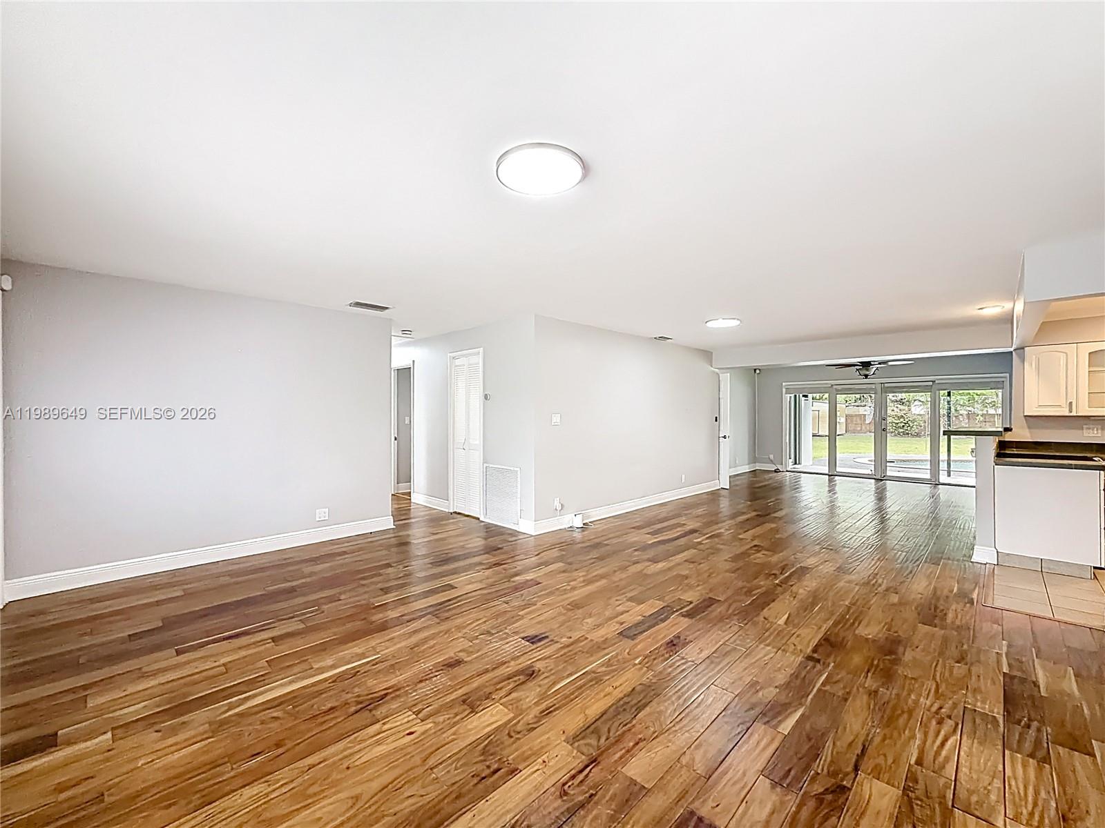 4330 Southwest 7th Street Plantation, FL 33317 - Photo 11 of 57 a view of empty room with wooden floor and windows