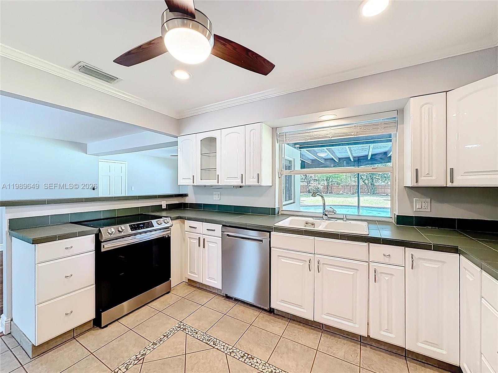4330 Southwest 7th Street Plantation, FL 33317 - Photo 14 of 57 a kitchen with white cabinets and white appliances