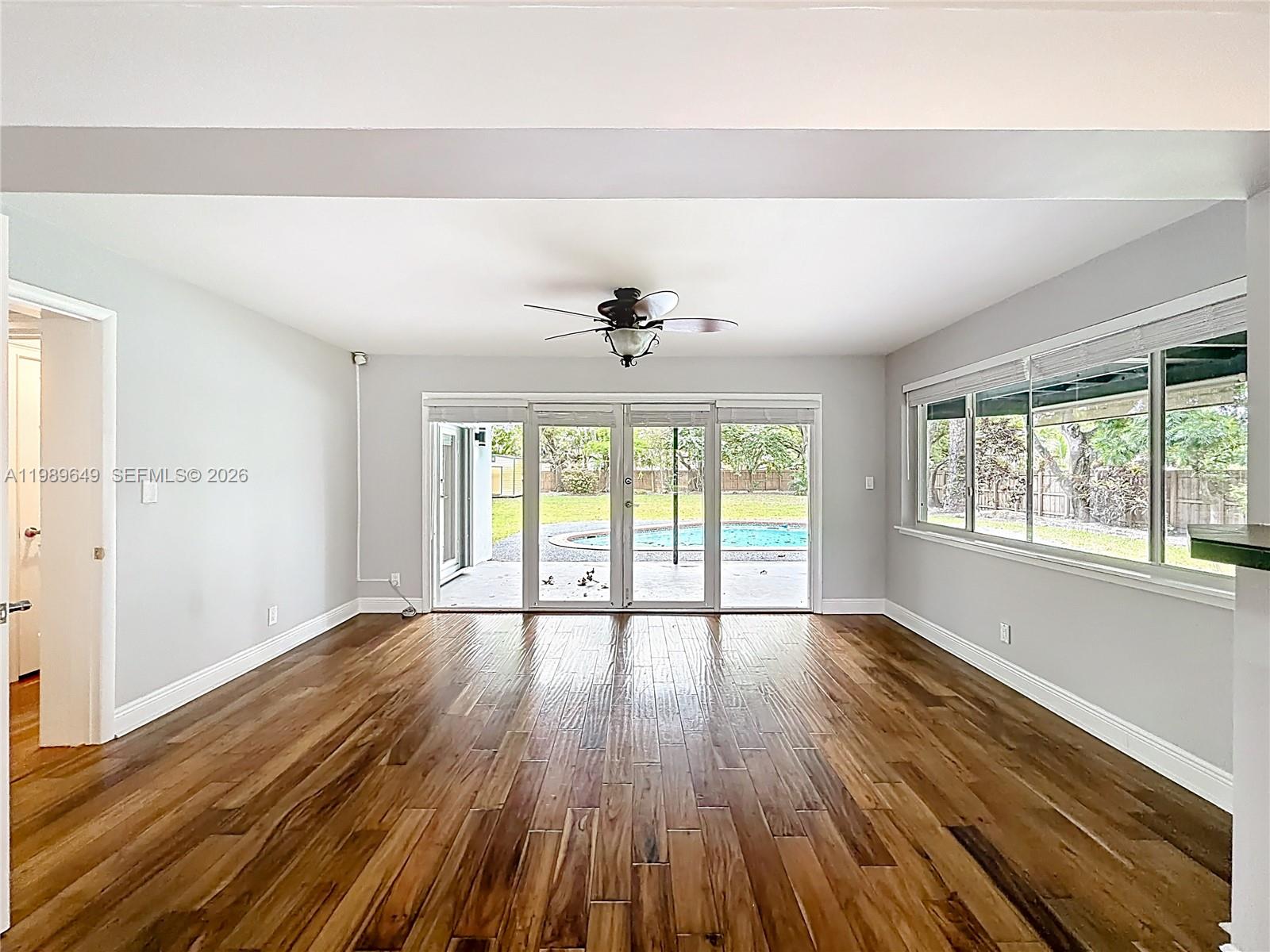 4330 Southwest 7th Street Plantation, FL 33317 - Photo 16 of 57 a view of an empty room with wooden floor and a window