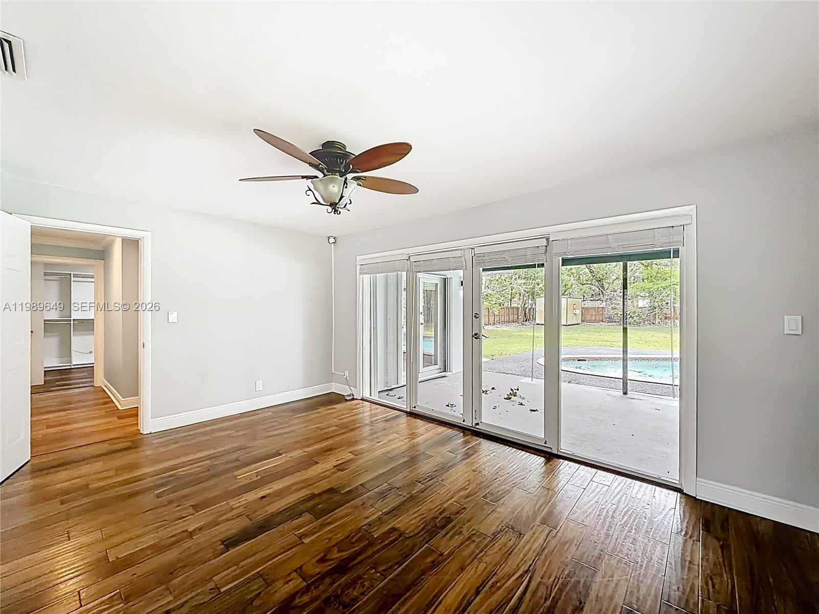4330 Southwest 7th Street Plantation, FL 33317 - Photo 17 of 57 an empty room with wooden floor and windows