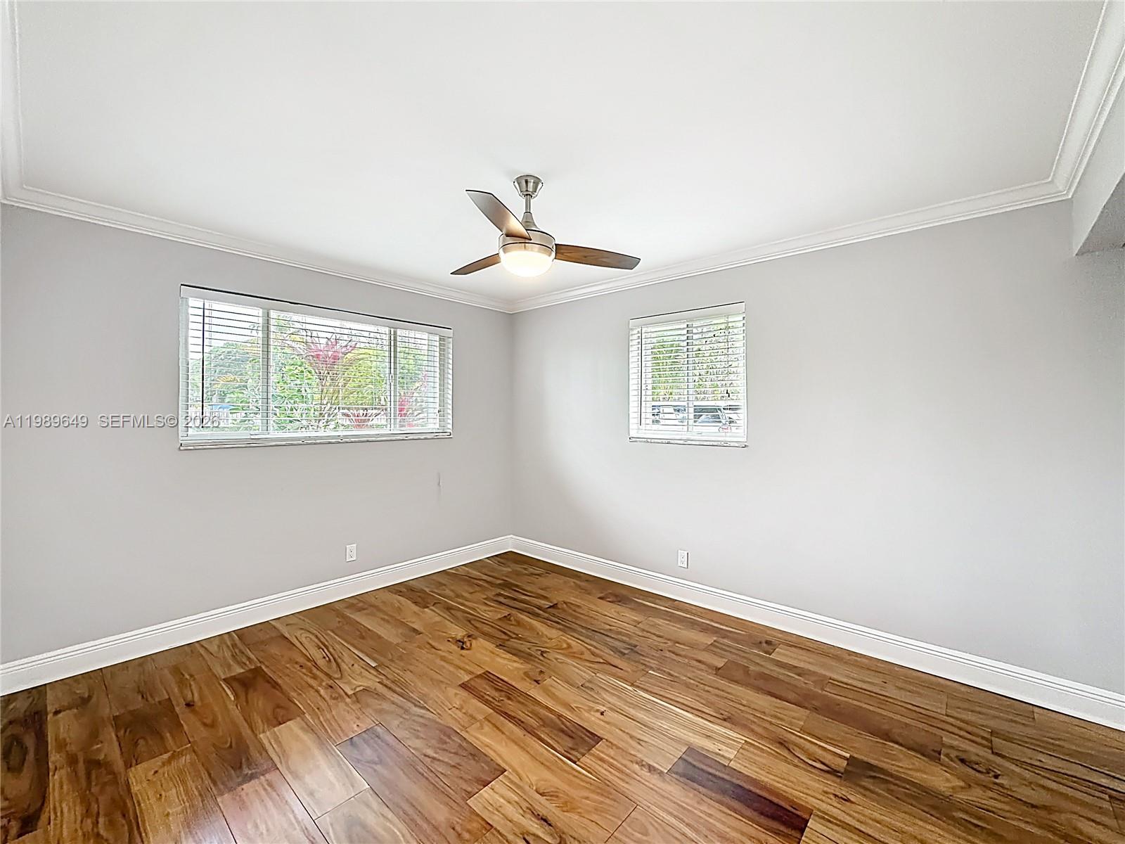 4330 Southwest 7th Street Plantation, FL 33317 - Photo 19 of 57 a view of a room with wooden floor and a ceiling fan
