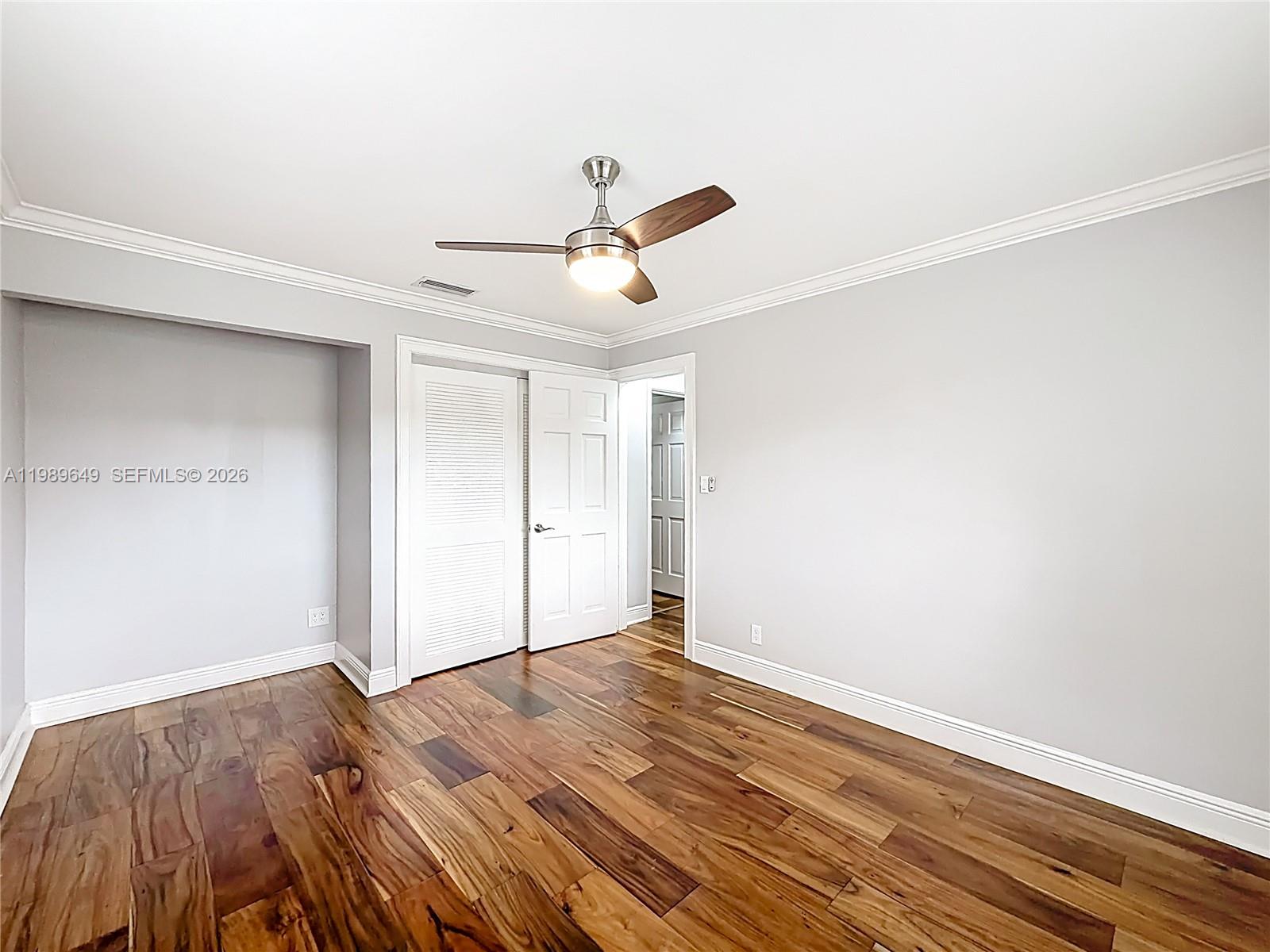 4330 Southwest 7th Street Plantation, FL 33317 - Photo 21 of 57 a view of a room with wooden floor and ceiling fan