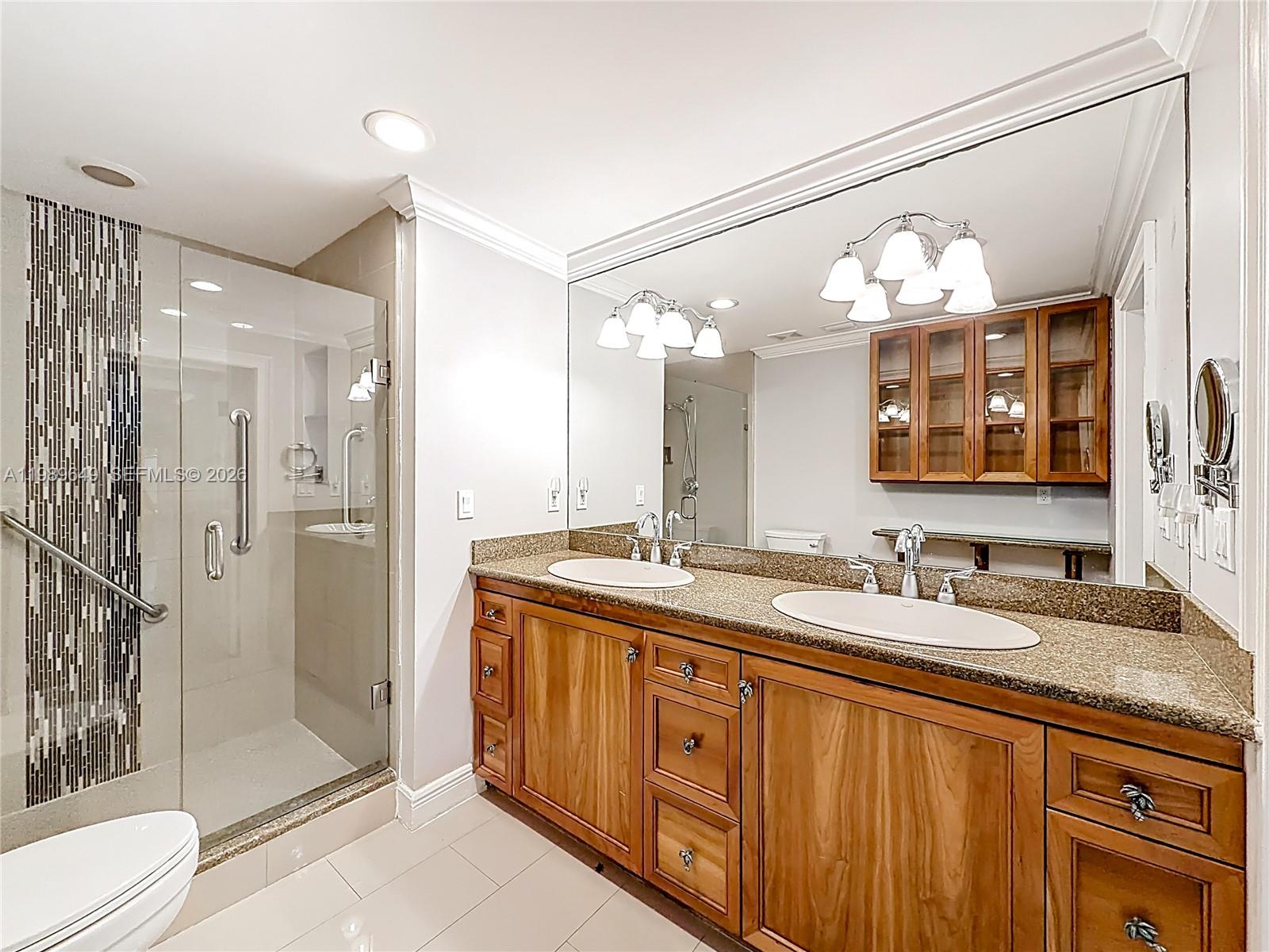 4330 Southwest 7th Street Plantation, FL 33317 - Photo 29 of 57 a bathroom with a double vanity sink mirror and shower