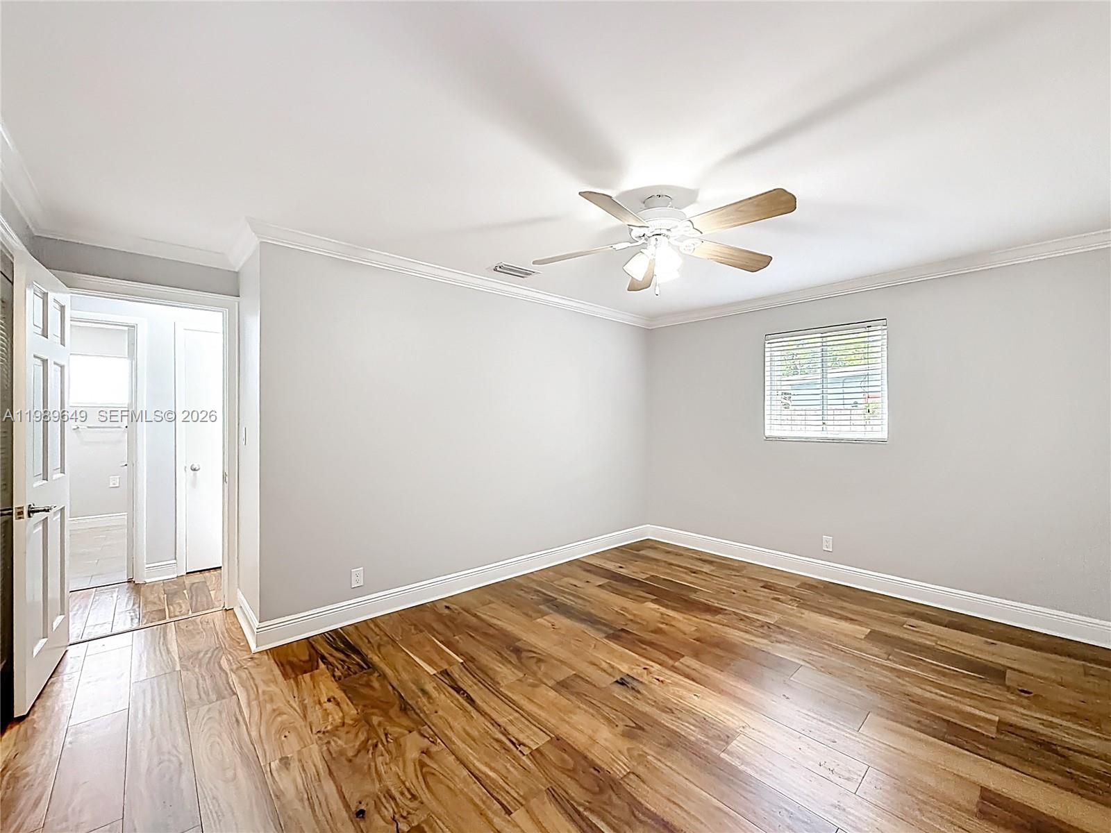 4330 Southwest 7th Street Plantation, FL 33317 - Photo 36 of 57 an empty room with wooden floor and windows