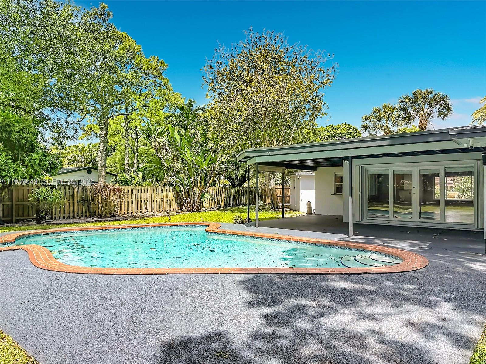 4330 Southwest 7th Street Plantation, FL 33317 - Photo 51 of 57 a view of a house with backyard and swimming pool