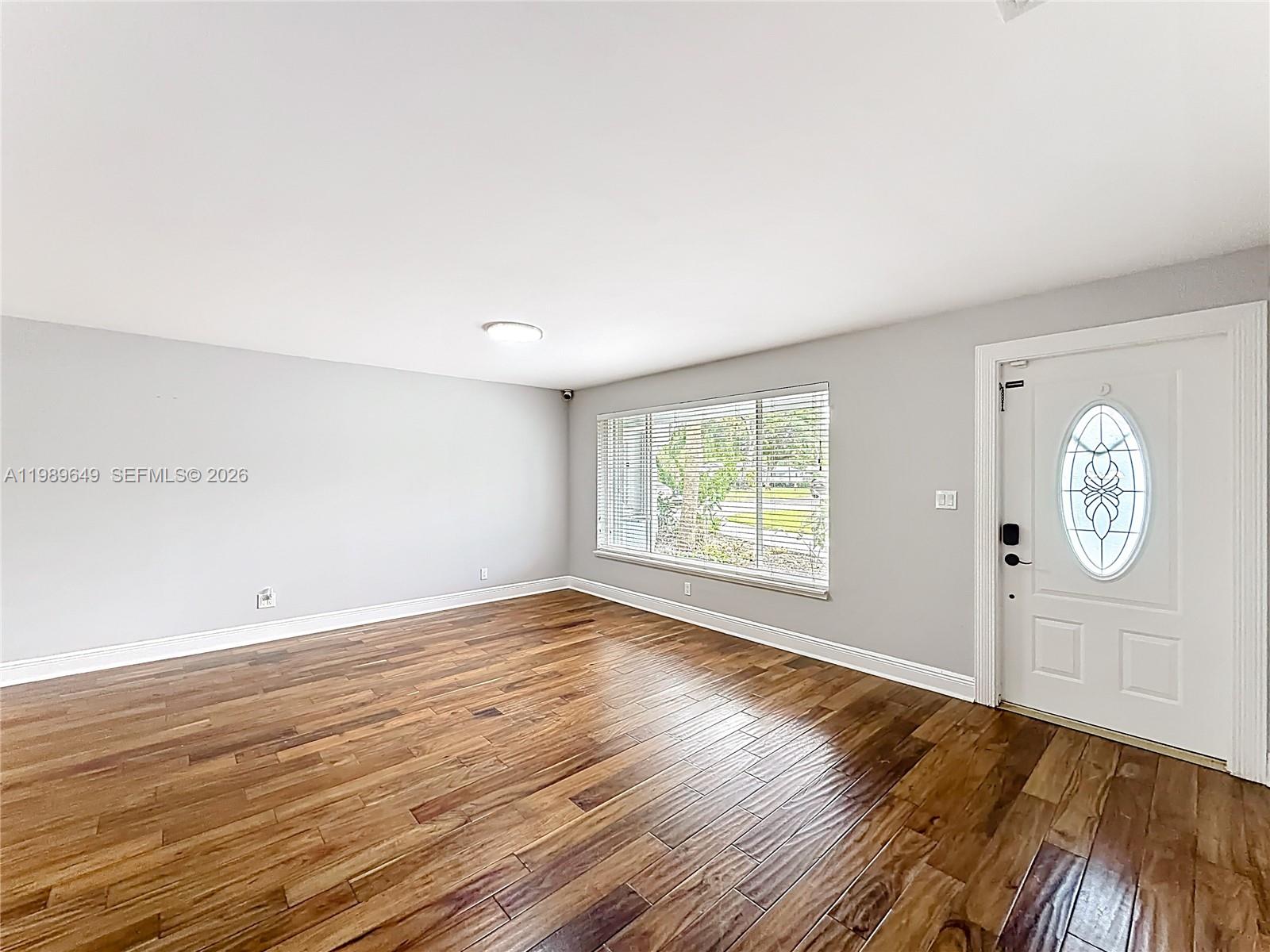 4330 Southwest 7th Street Plantation, FL 33317 - Photo 8 of 57 an empty room with wooden floor and window