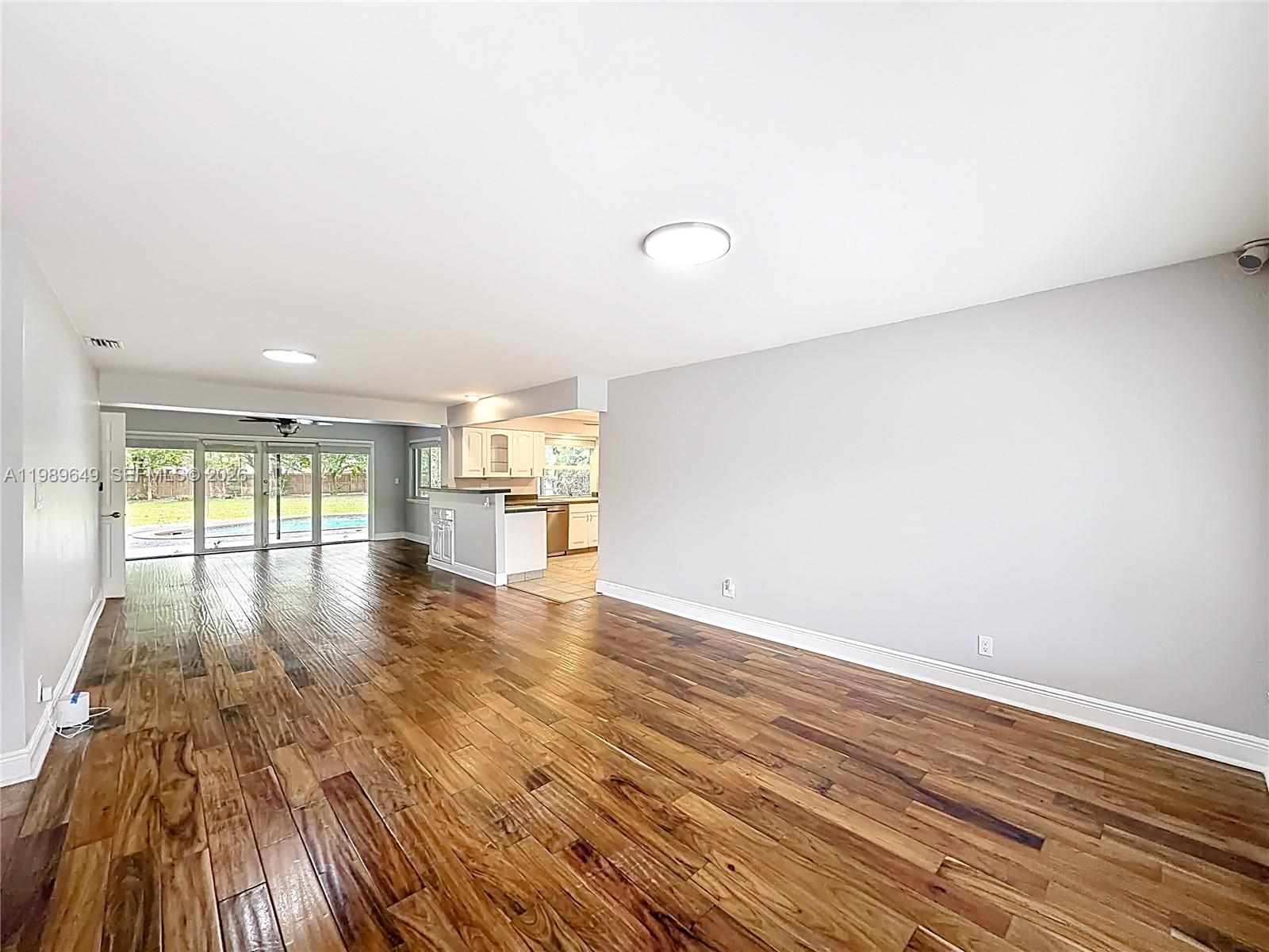 4330 Southwest 7th Street Plantation, FL 33317 - Photo 10 of 57 a view of empty room with wooden floor and fan