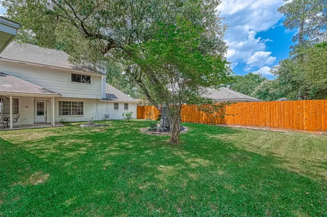 a backyard of a house with table and chairs