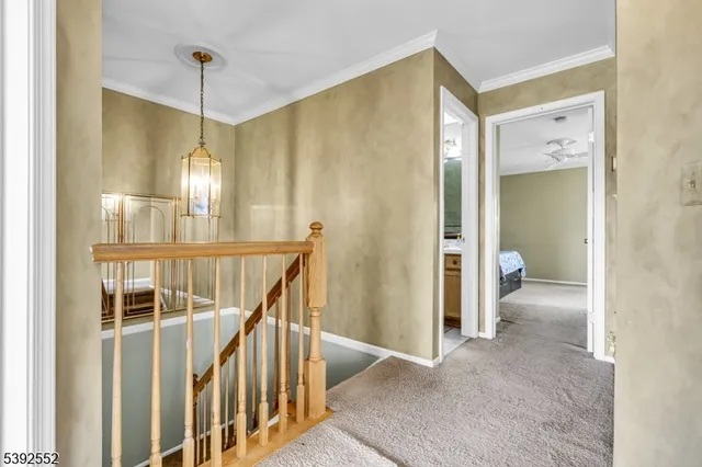 a view of a hallway with wooden floor and entryway