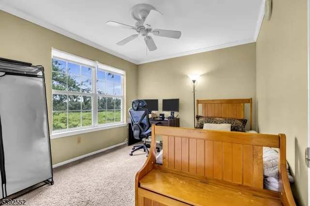 a work room with furniture and a flat screen tv