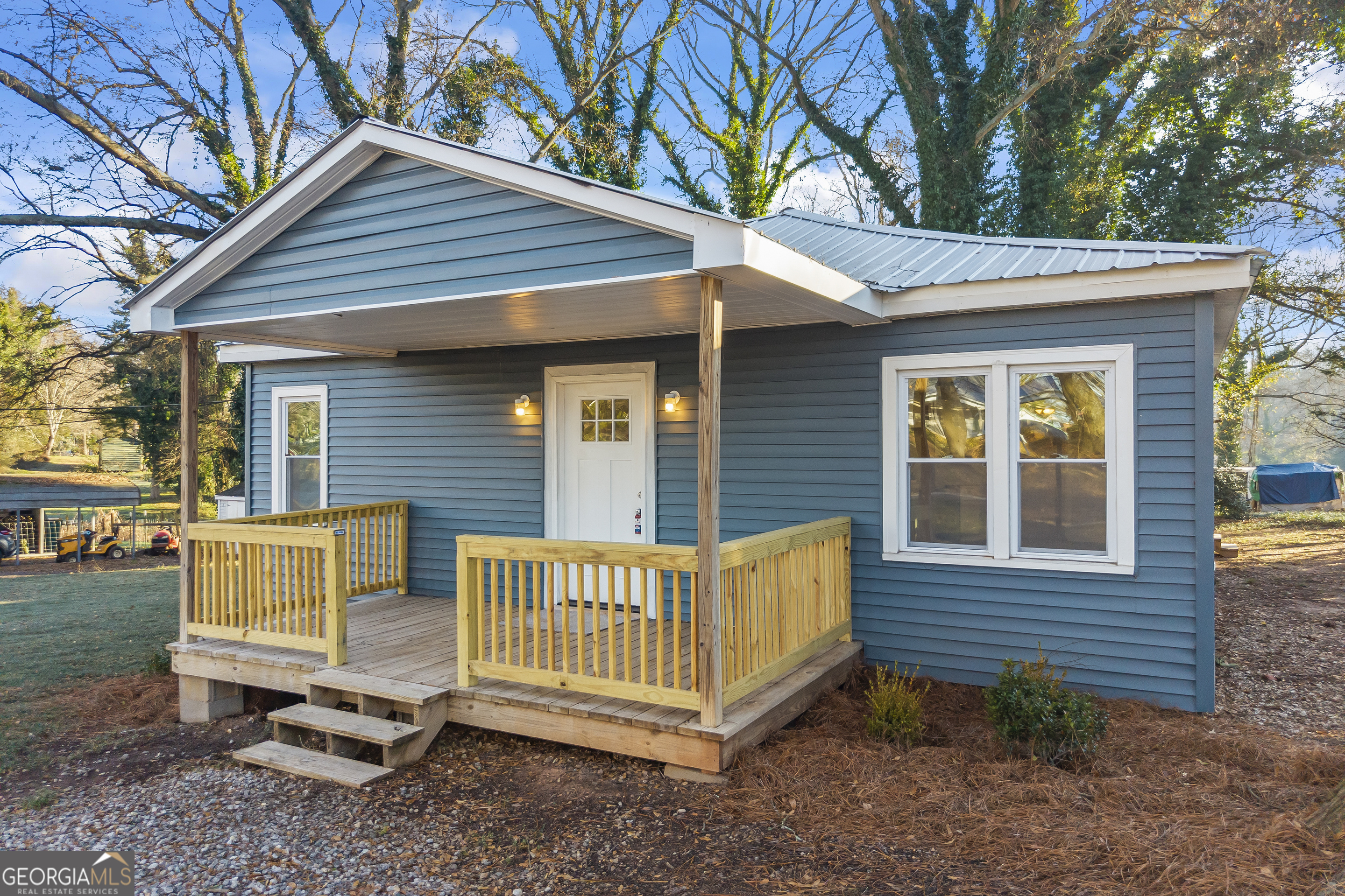 a view of a house with a yard and wooden fence