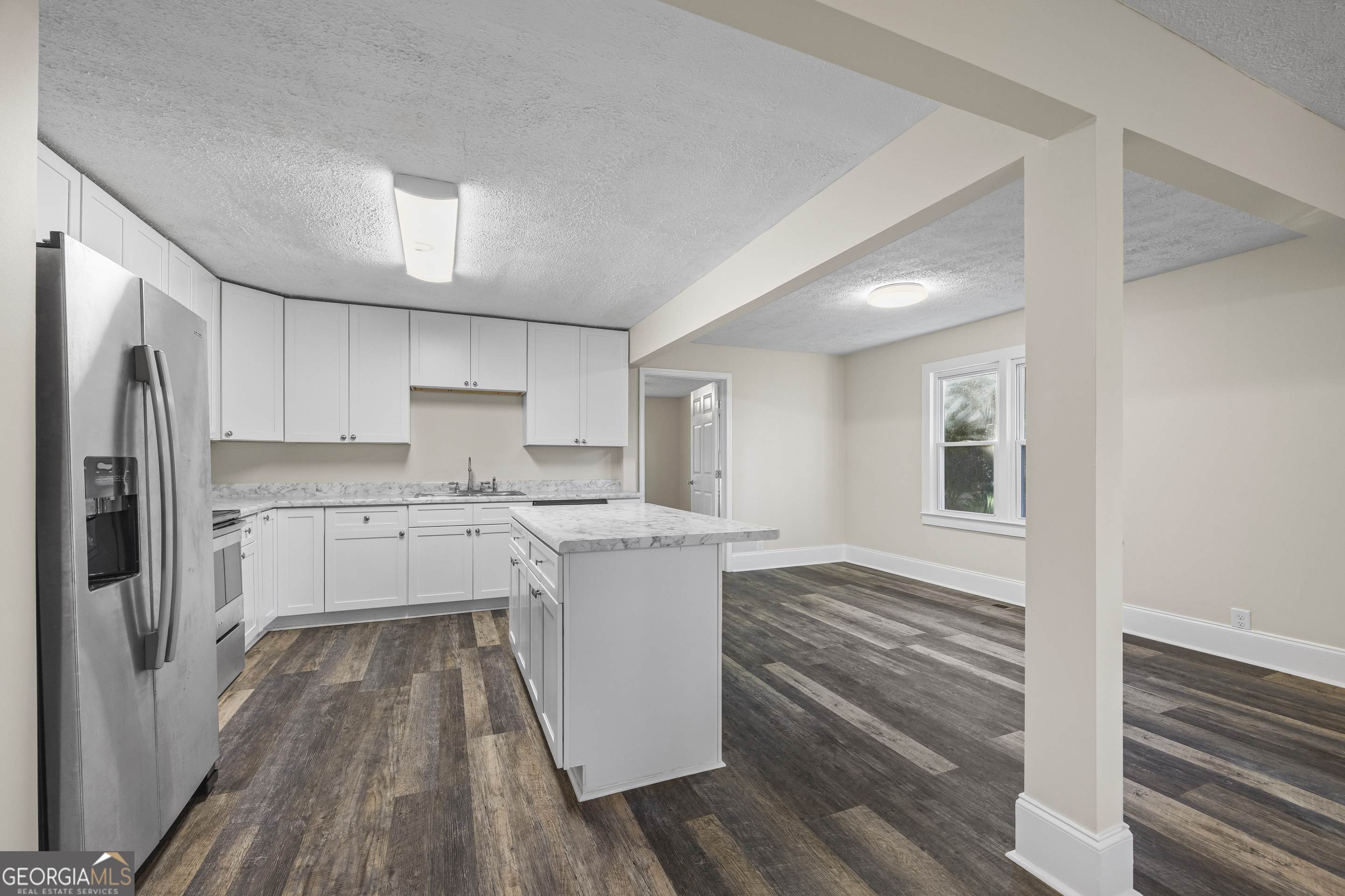 9750 Lavonia Road Carnesville, GA 30521 - Photo 13 of 49 a kitchen with a sink stainless steel appliances a refrigerator and cabinets
