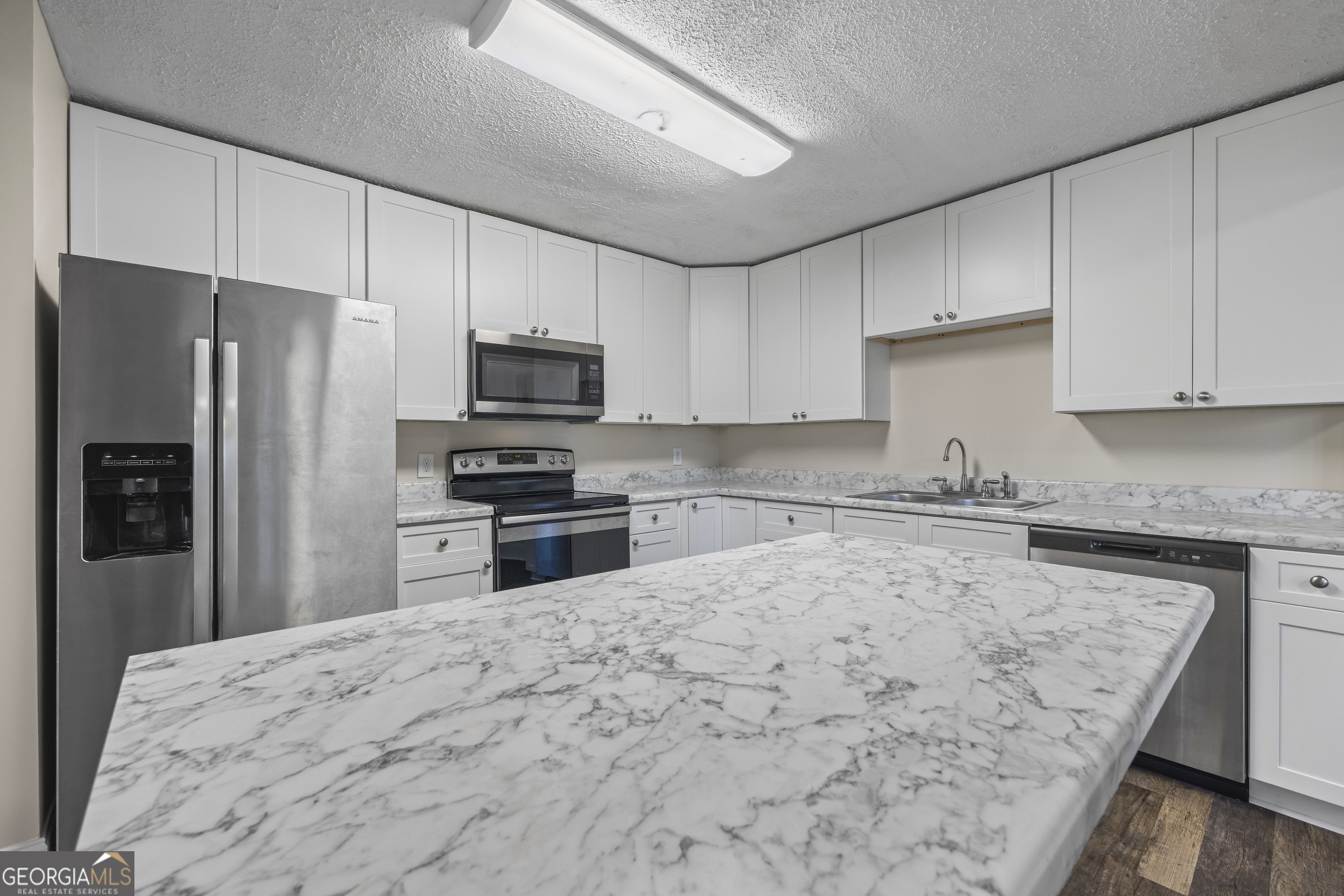 9750 Lavonia Road Carnesville, GA 30521 - Photo 16 of 49 a kitchen with granite countertop a refrigerator sink and microwave