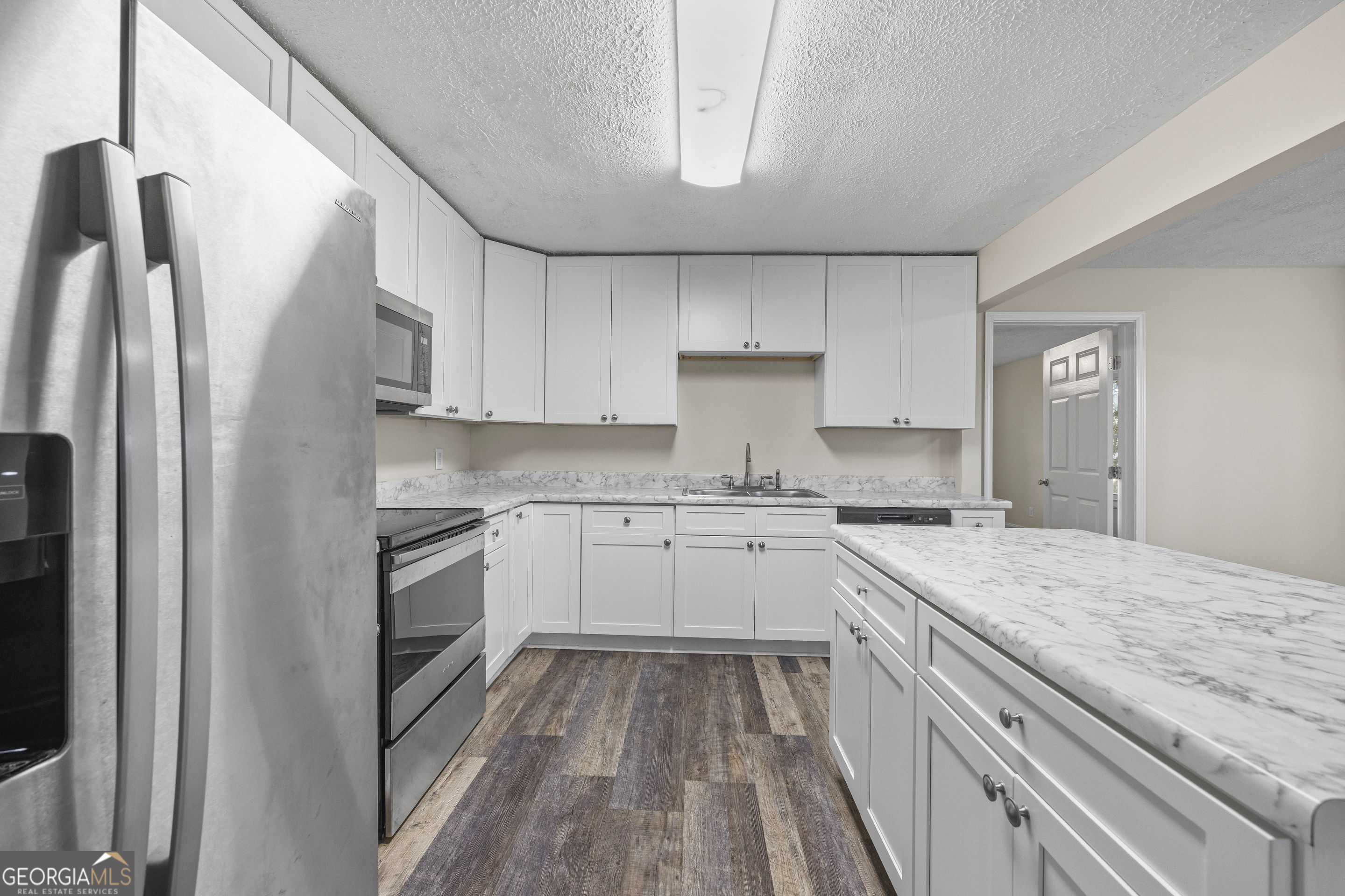 9750 Lavonia Road Carnesville, GA 30521 - Photo 18 of 49 a kitchen with a sink stove and refrigerator
