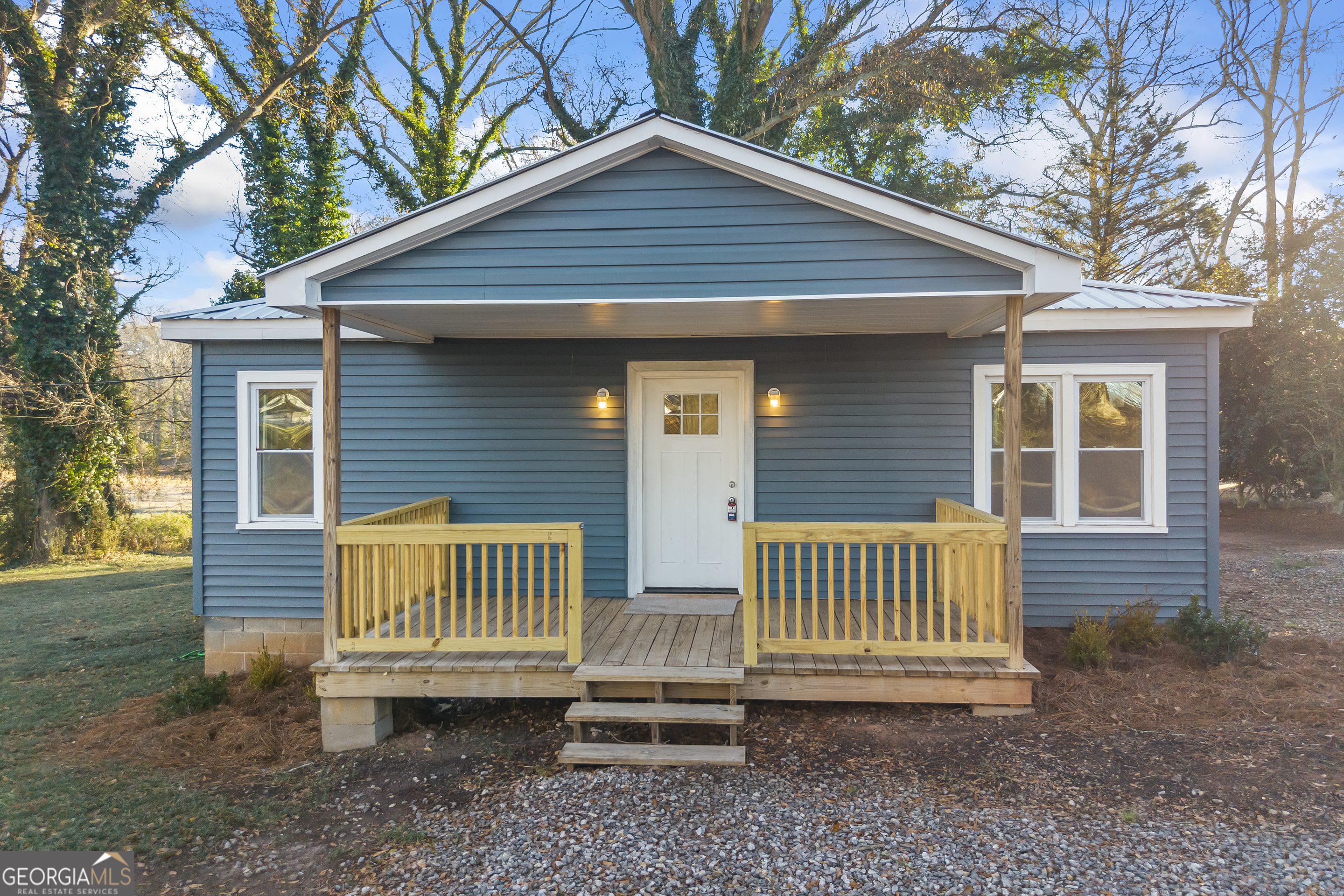 9750 Lavonia Road Carnesville, GA 30521 - Photo 2 of 49 a view of a house with a yard and wooden deck