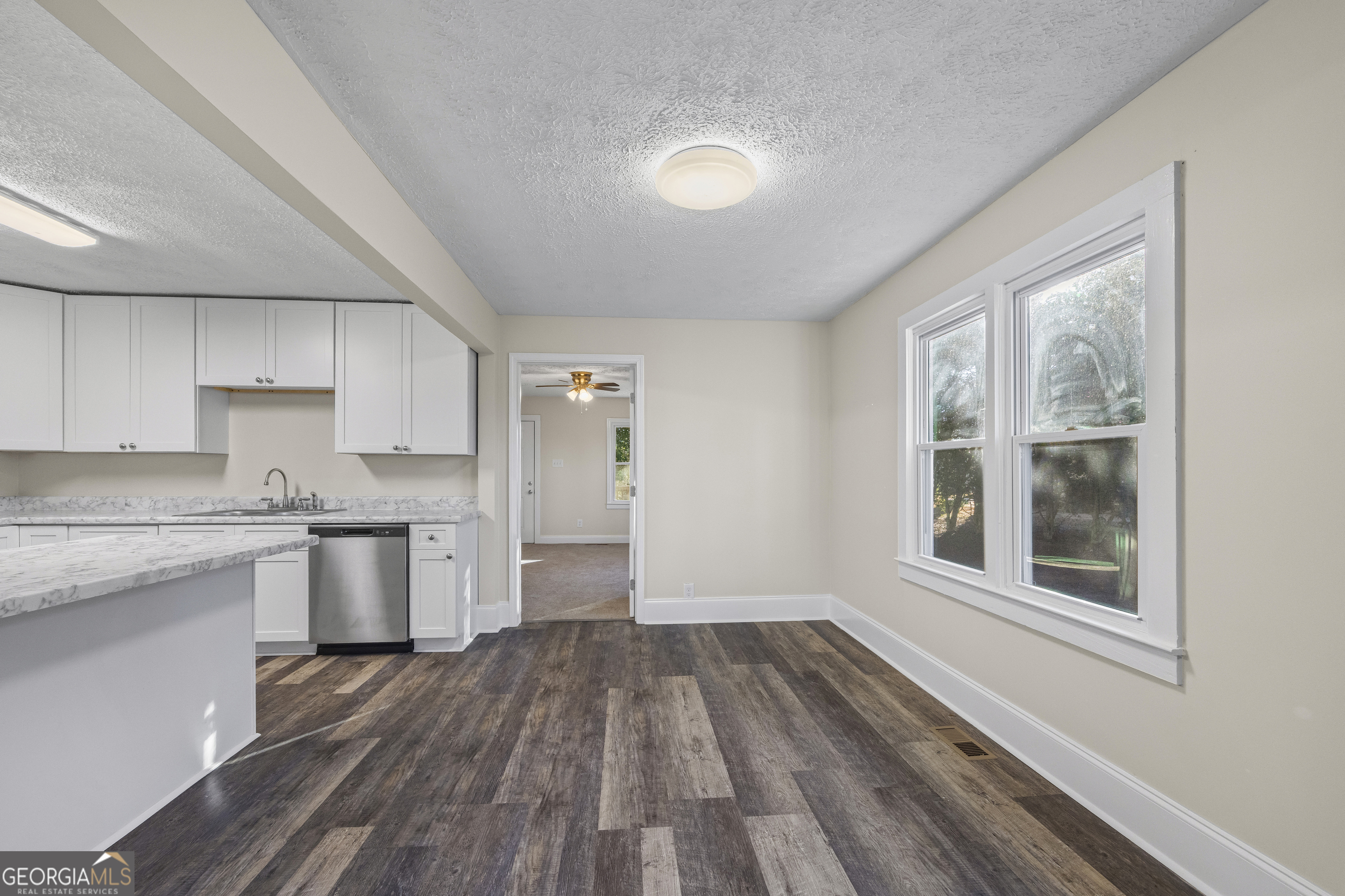 9750 Lavonia Road Carnesville, GA 30521 - Photo 21 of 49 a kitchen with a wooden floor and a window