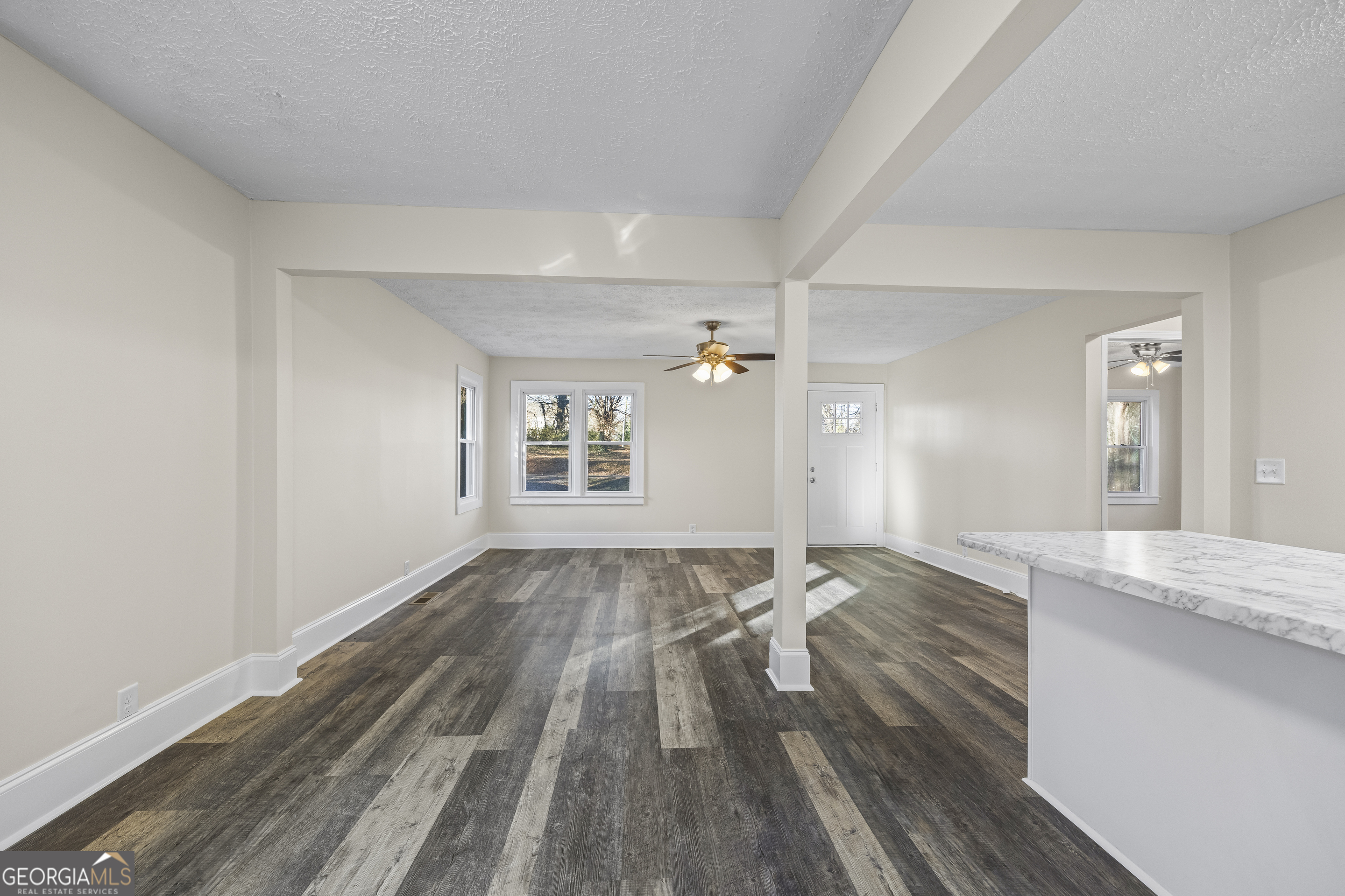 9750 Lavonia Road Carnesville, GA 30521 - Photo 22 of 49 a view of a livingroom with wooden floor and staircase
