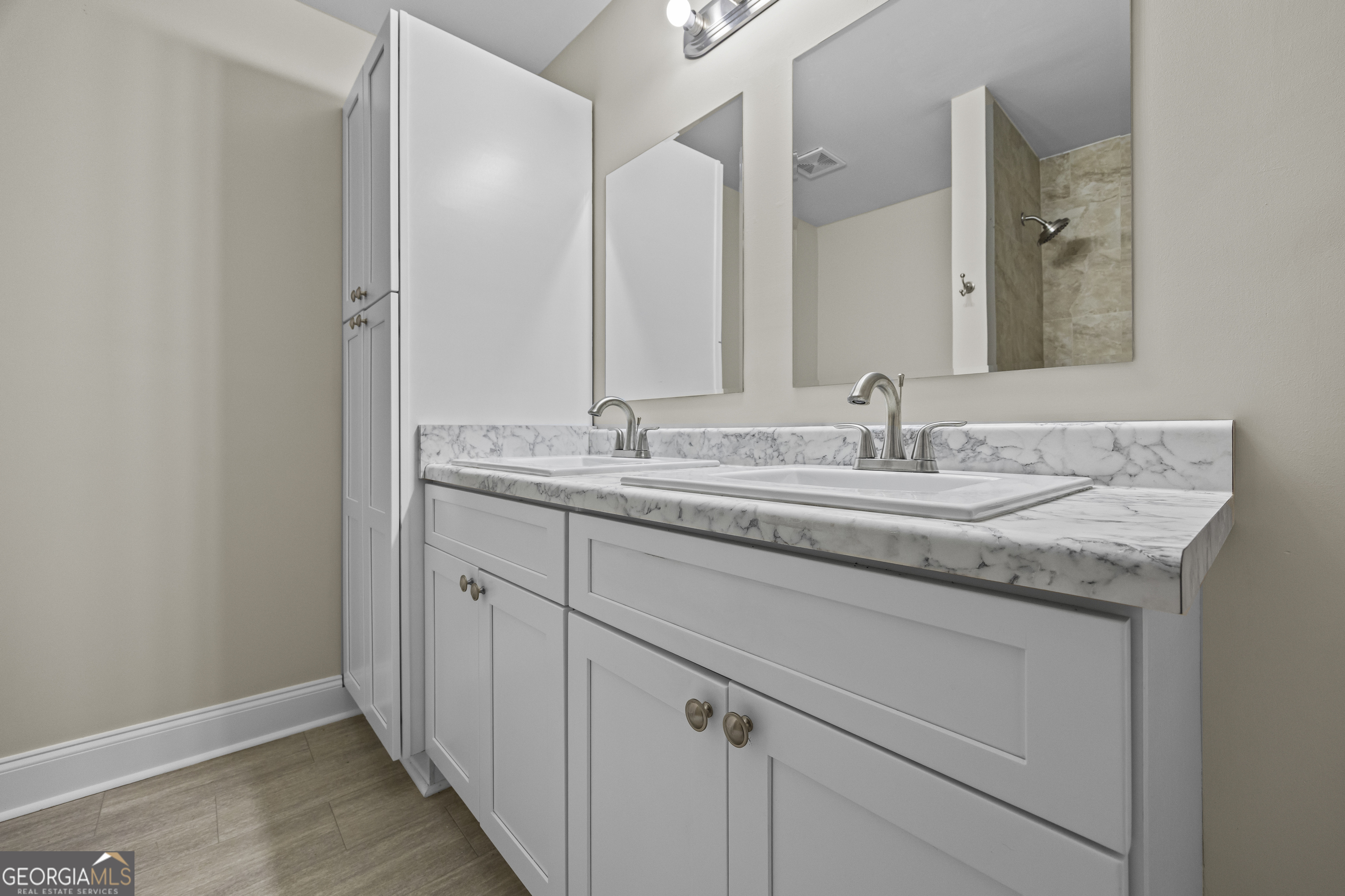 9750 Lavonia Road Carnesville, GA 30521 - Photo 30 of 49 a bathroom with a granite countertop sink and a mirror