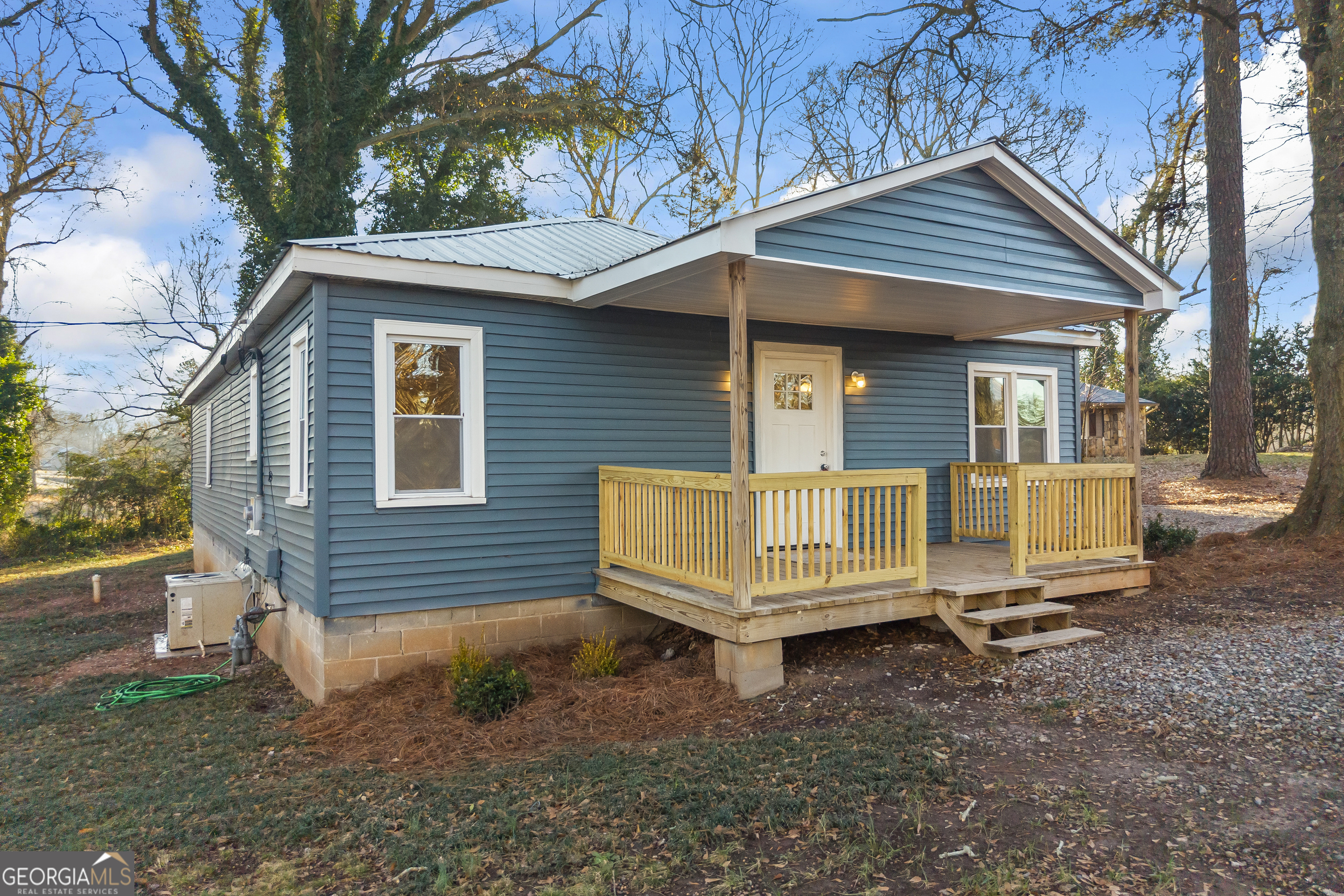 9750 Lavonia Road Carnesville, GA 30521 - Photo 3 of 49 a view of a house with a yard chairs and wooden fence