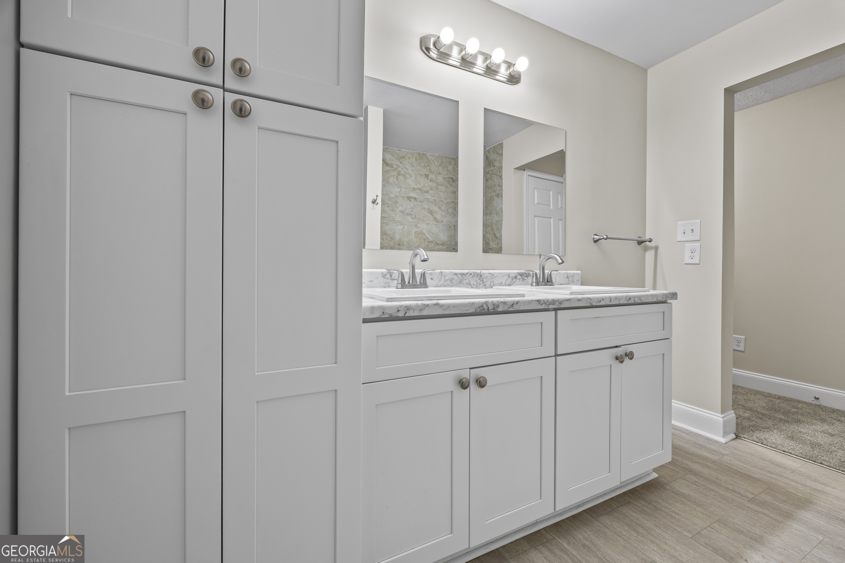 9750 Lavonia Road Carnesville, GA 30521 - Photo 31 of 49 a bathroom with a double vanity sink and a mirror