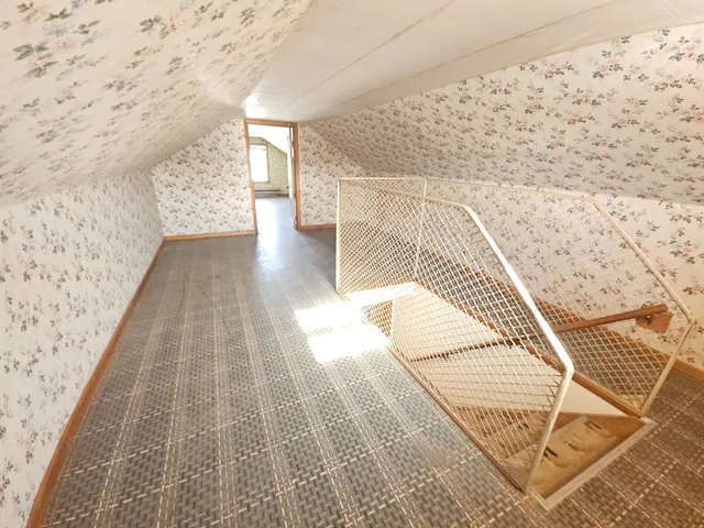 a view of a room with wooden floor