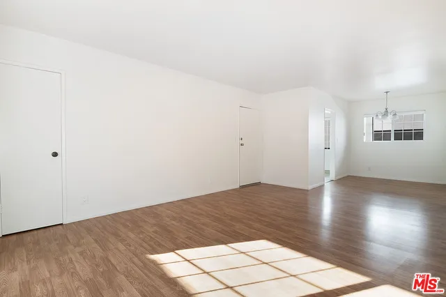 an empty room with wooden floor
