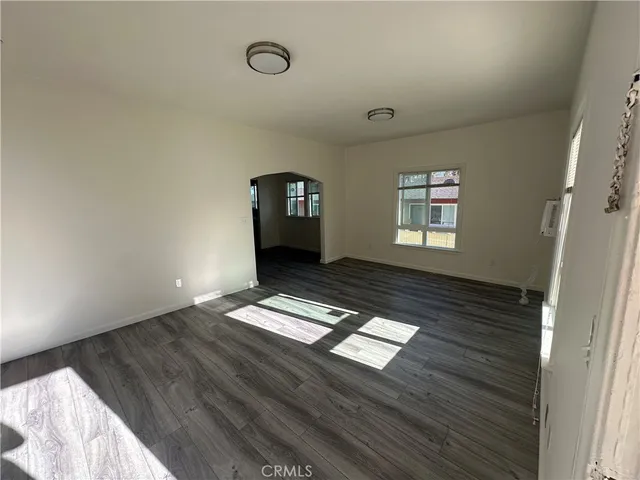 a view of wooden floor and windows in a room