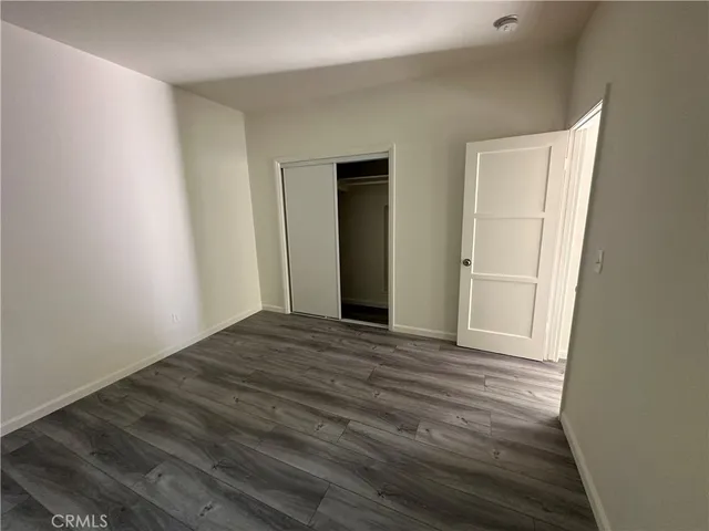 a view of a livingroom with wooden floor and closet