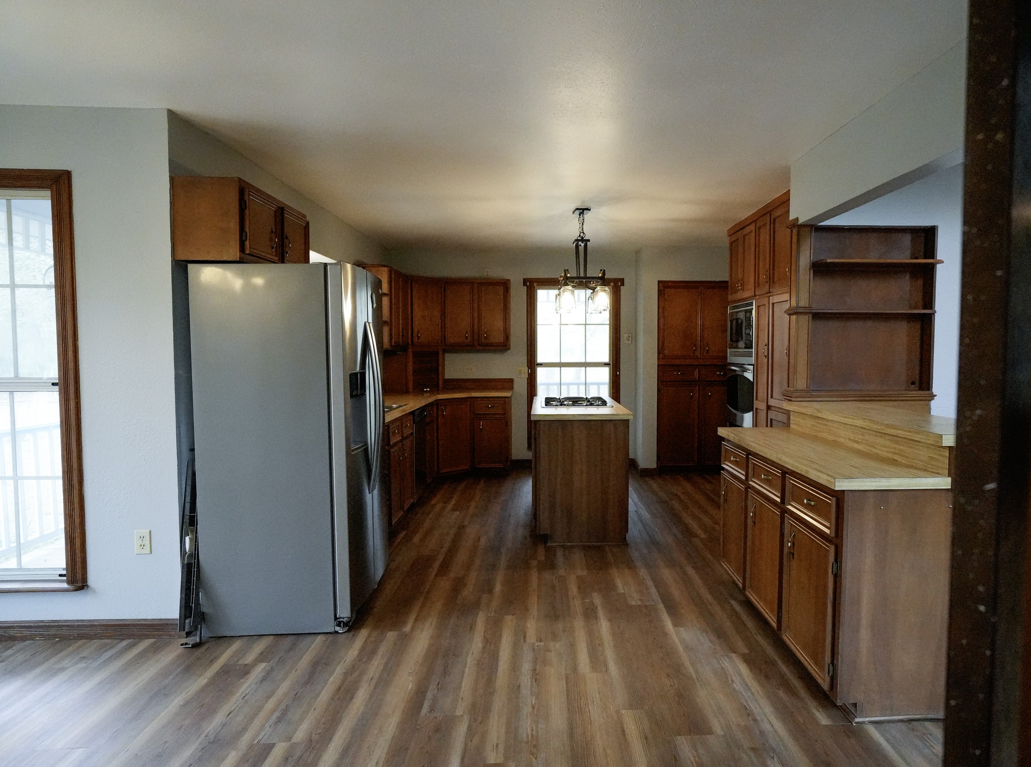 4731 Krischke Road Schulenburg, TX 78956 - Photo 21 of 40 a kitchen with stainless steel appliances granite countertop a refrigerator a stove and a wooden floors