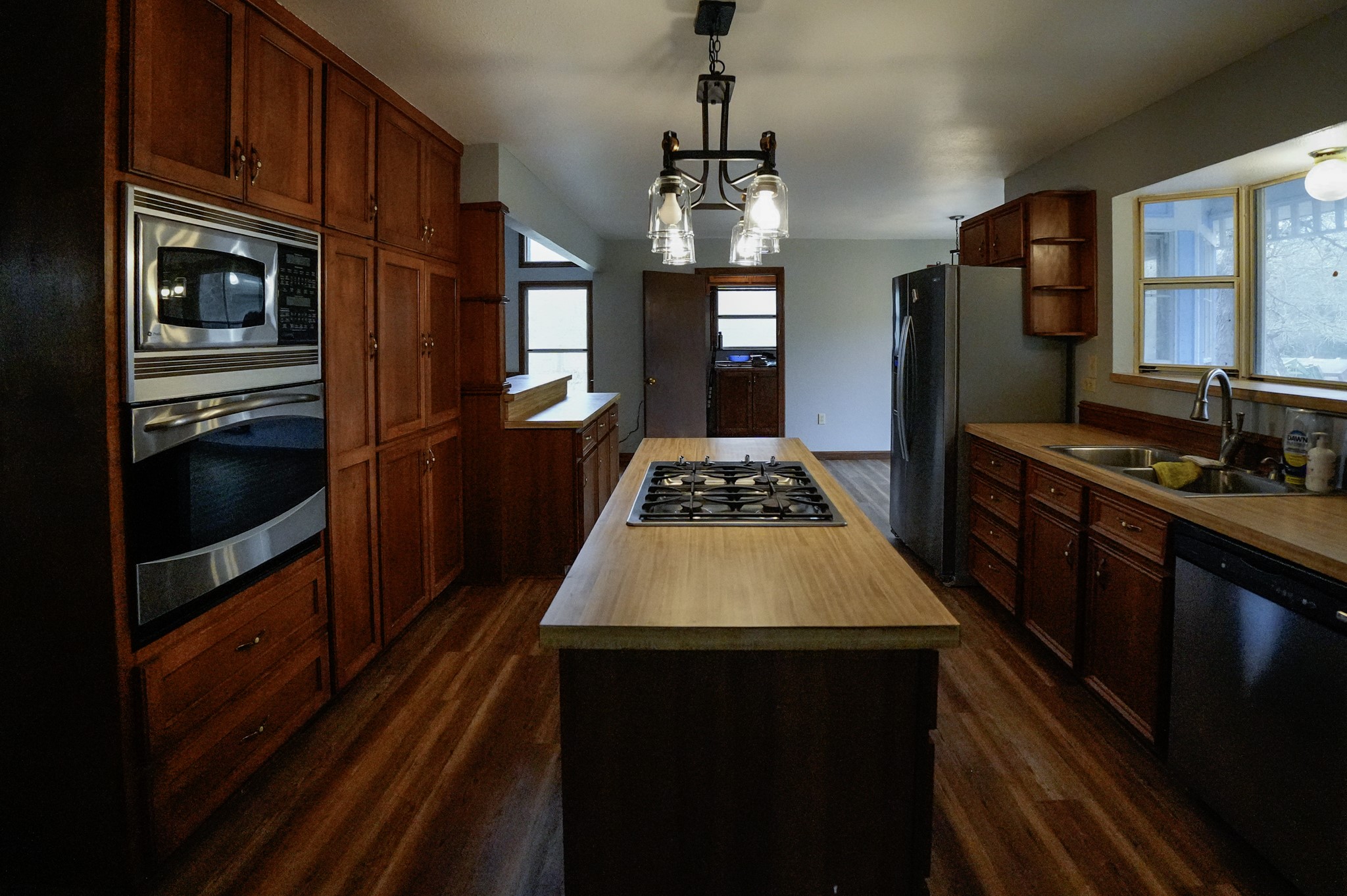 4731 Krischke Road Schulenburg, TX 78956 - Photo 22 of 40 a kitchen with stainless steel appliances granite countertop a stove refrigerator and a kitchen island