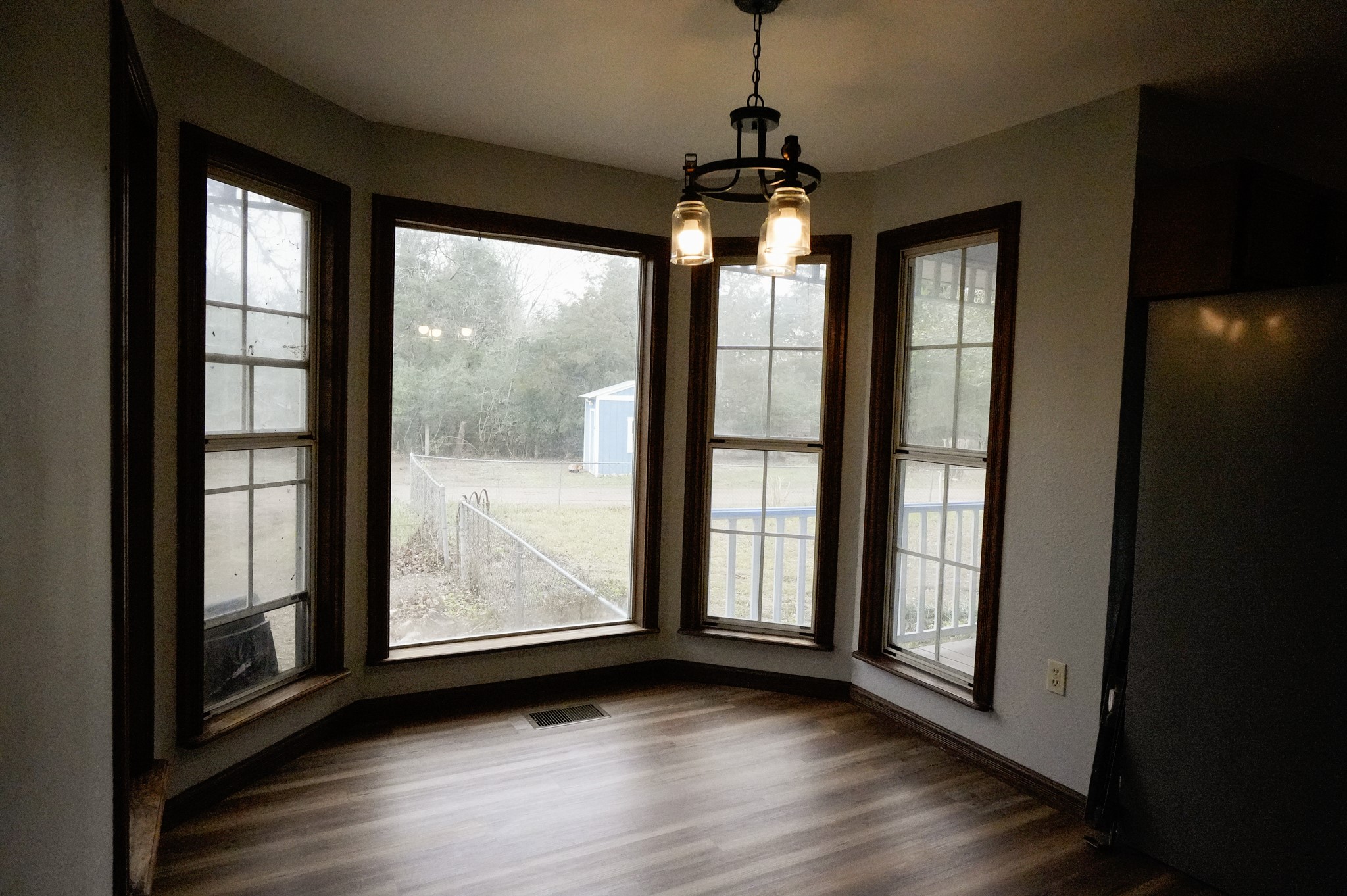 4731 Krischke Road Schulenburg, TX 78956 - Photo 23 of 40 a view of wooden floor and windows in an empty room