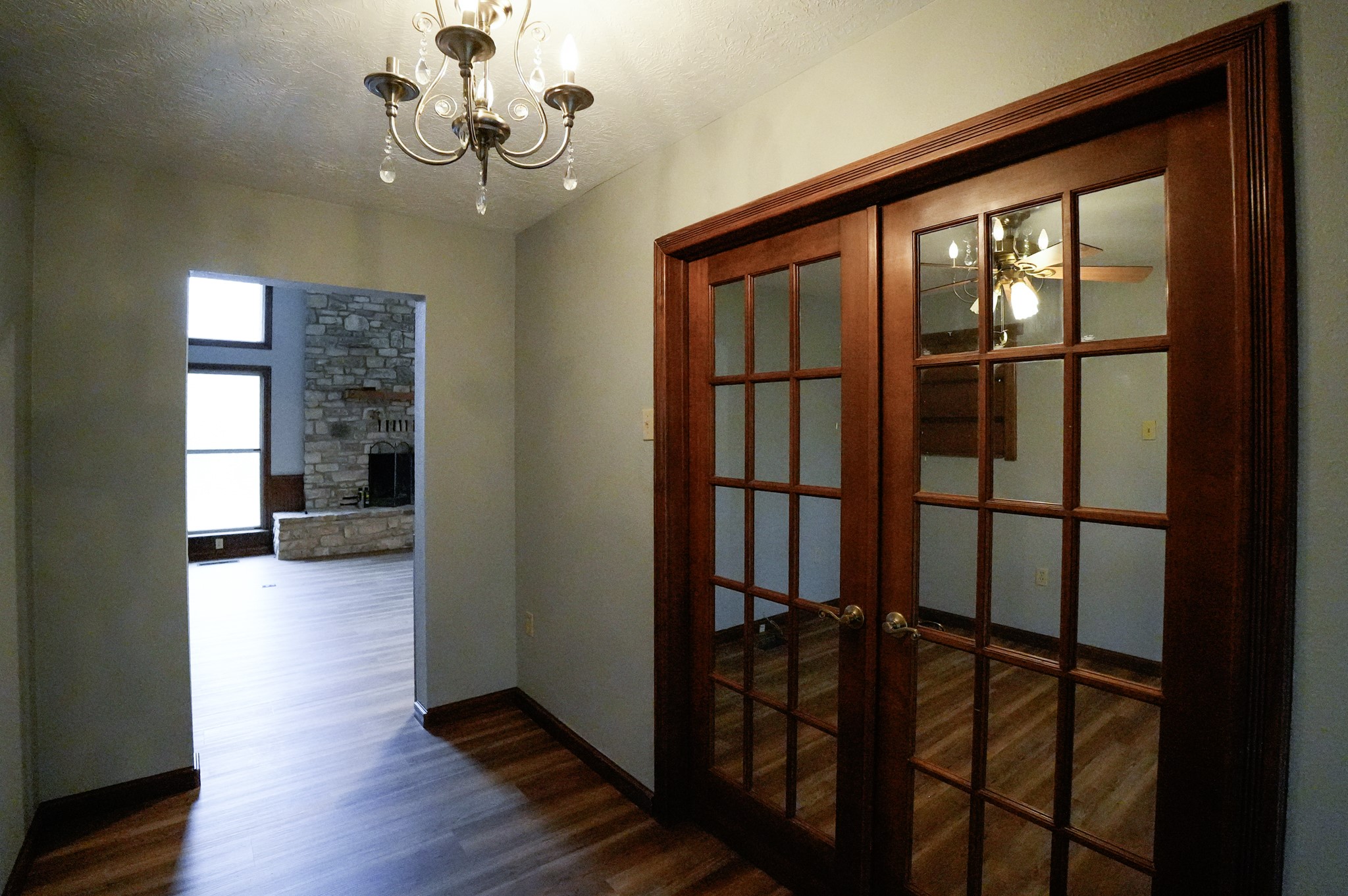 4731 Krischke Road Schulenburg, TX 78956 - Photo 26 of 40 a view of a hallway and wooden floor and a chandelier