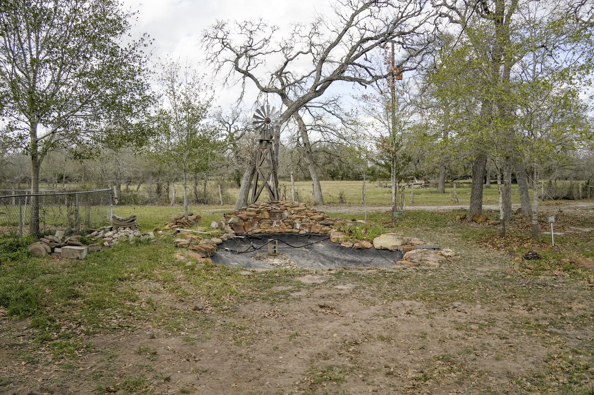 4731 Krischke Road Schulenburg, TX 78956 - Photo 7 of 40 a view of a lake with a yard and covered with tall trees