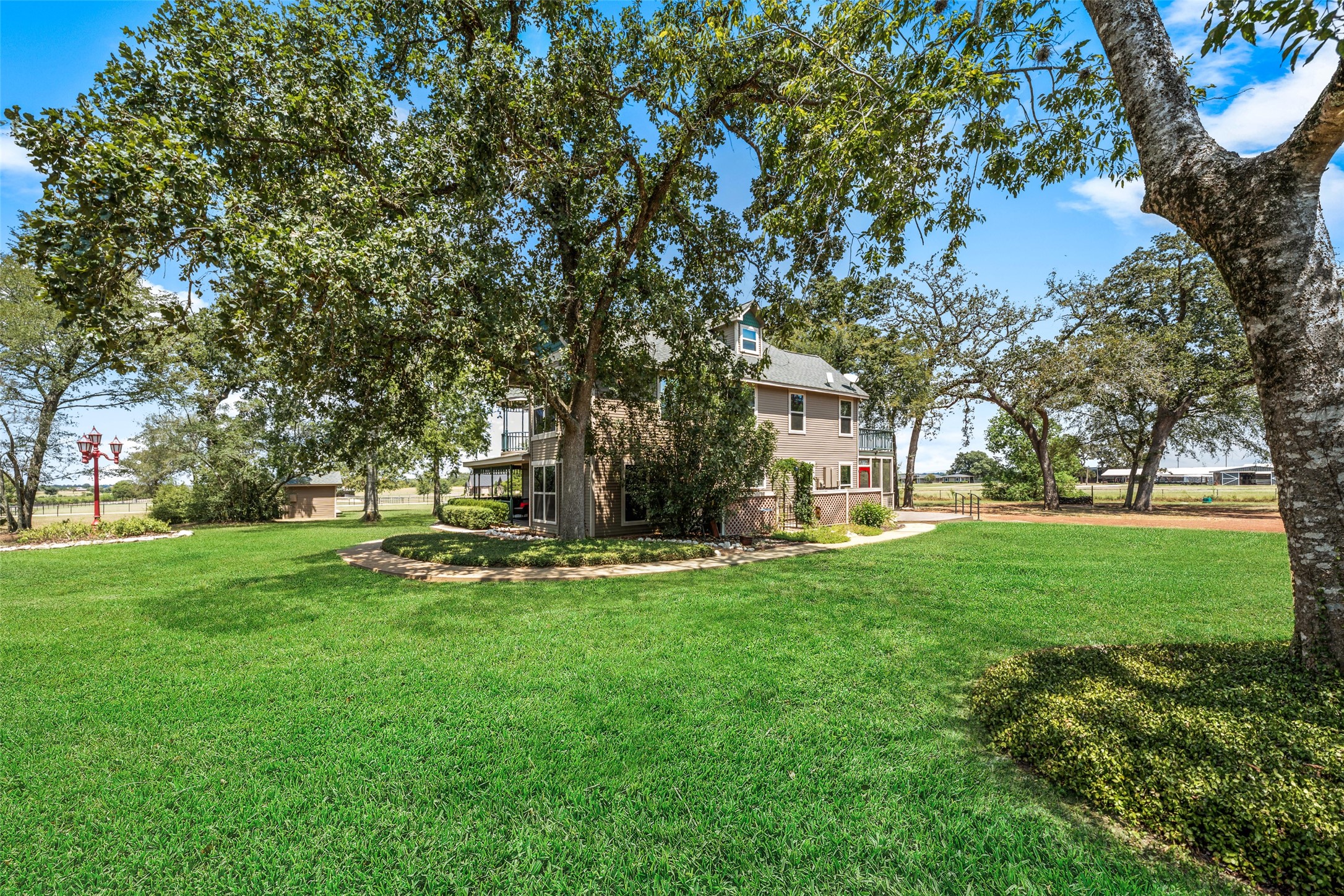 25948 Nelson Road Hempstead, TX 77445 - Photo 46 of 46 Beautifully maintained grounds with sprawling mature trees providing abundant shade and a picturesque setting.