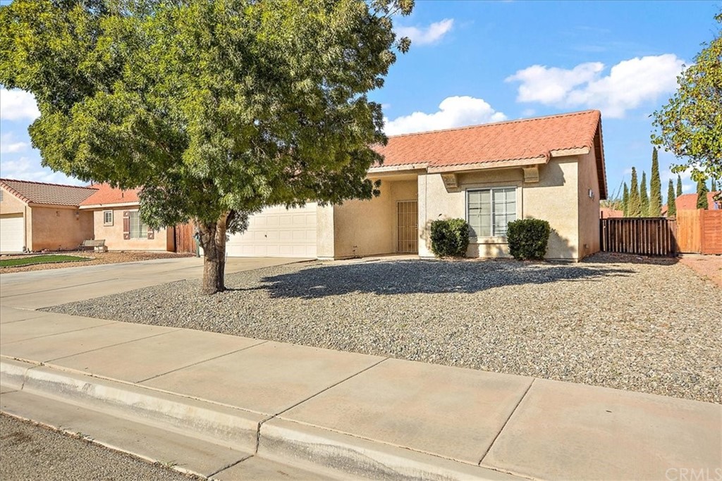 14560 Juniper Lane Adelanto, CA 92301 - Photo 2 of 25 a front view of a house with a yard