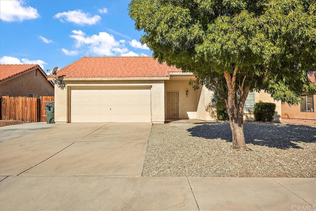 14560 Juniper Lane Adelanto, CA 92301 - Photo 3 of 25 a house with trees in front of it