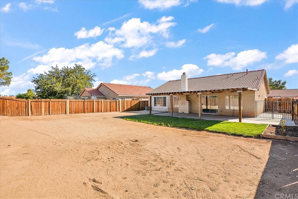 14560 Juniper Lane Adelanto, CA 92301 - Photo 23 of 25 a view of a white house with a yard