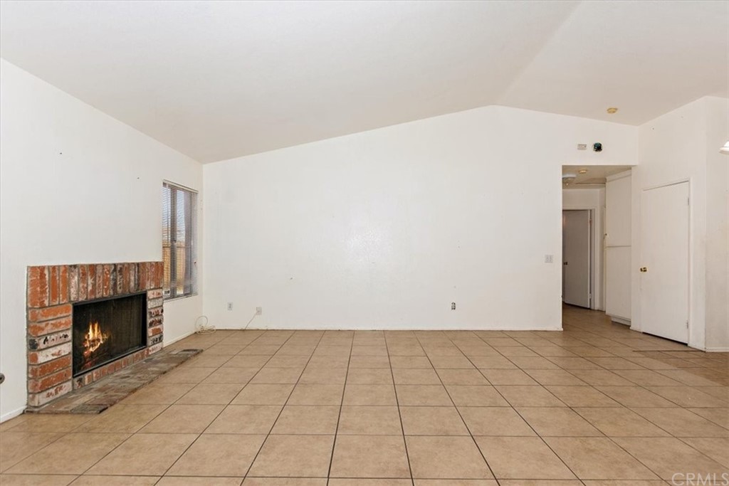 14560 Juniper Lane Adelanto, CA 92301 - Photo 4 of 25 an empty room with fireplace