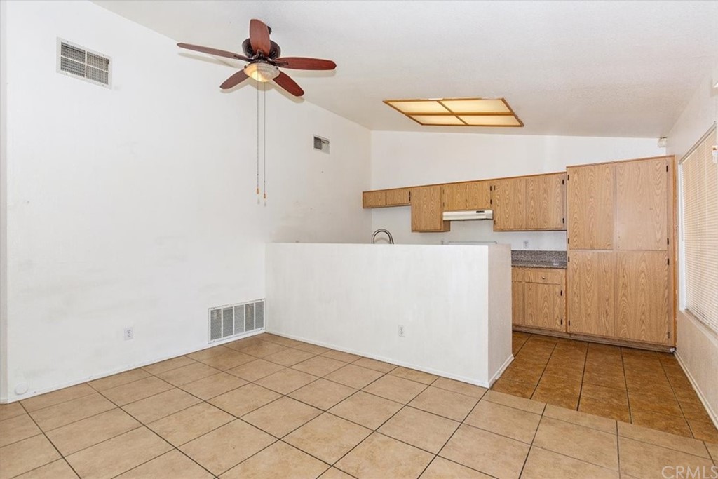 14560 Juniper Lane Adelanto, CA 92301 - Photo 8 of 25 a utility room with a washer dryer and white cabinets