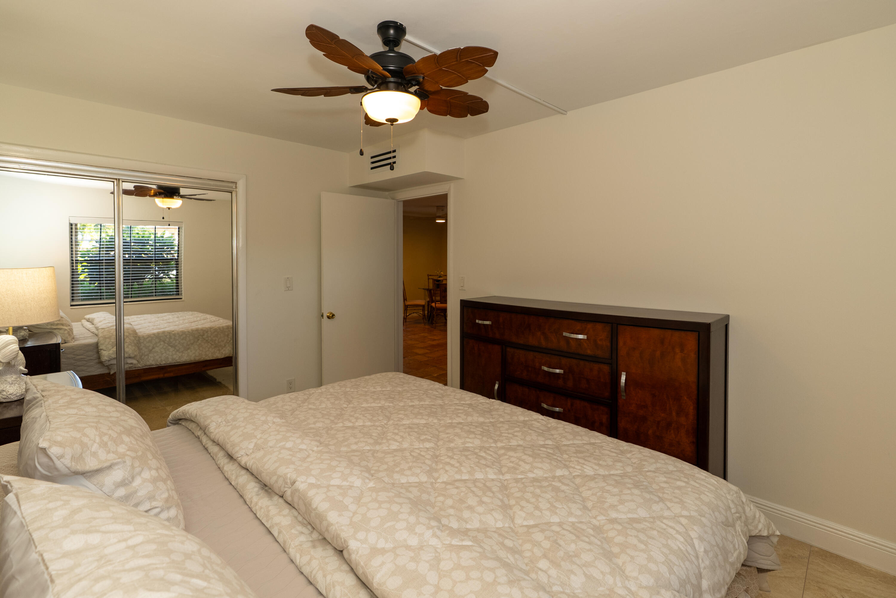 300 Inlet Way, Unit 2 Palm Beach Shores, FL 33404 - Photo 15 of 18 a bedroom with a bed and a chandelier