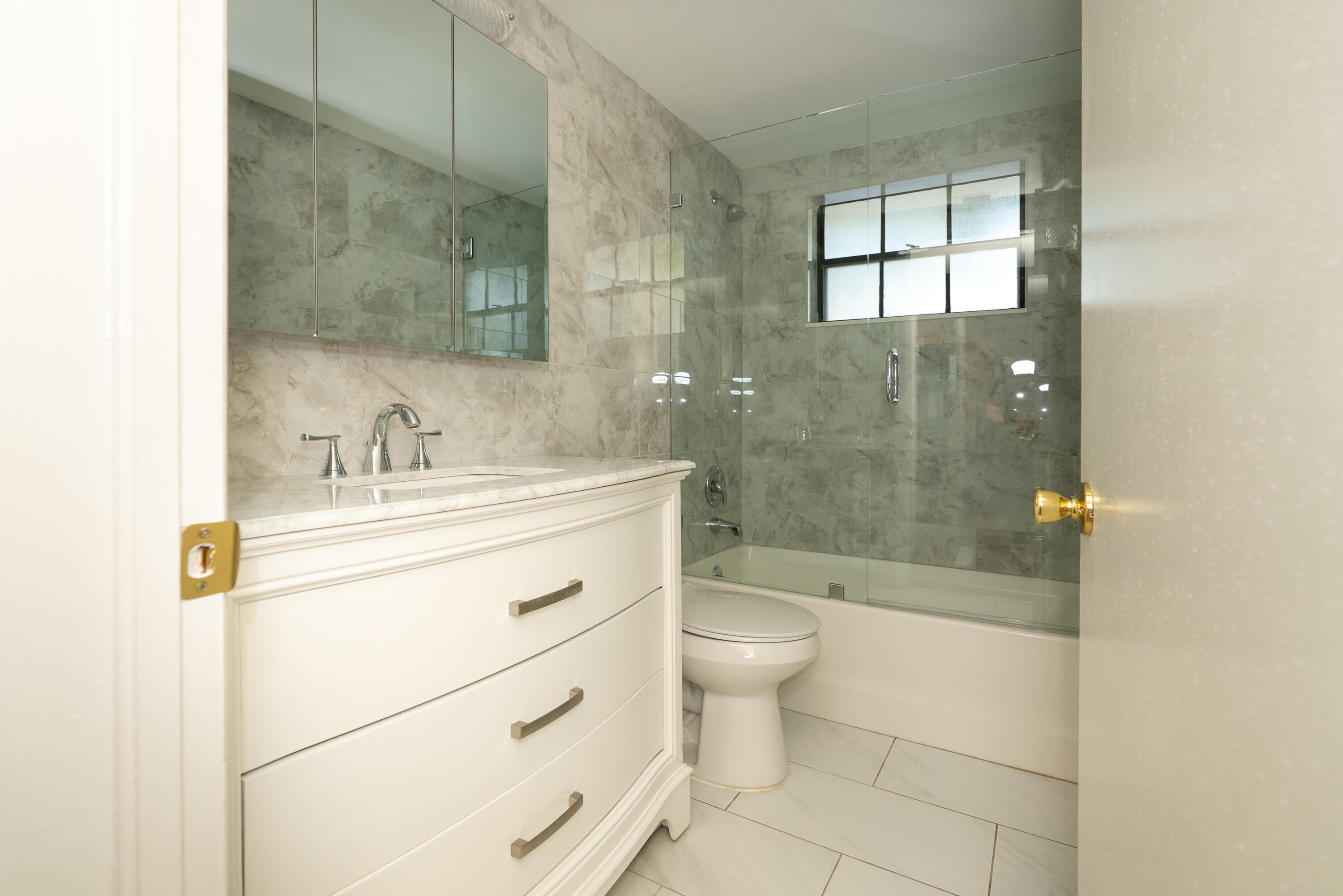 300 Inlet Way, Unit 2 Palm Beach Shores, FL 33404 - Photo 17 of 18 a bathroom with a sink a toilet and shower