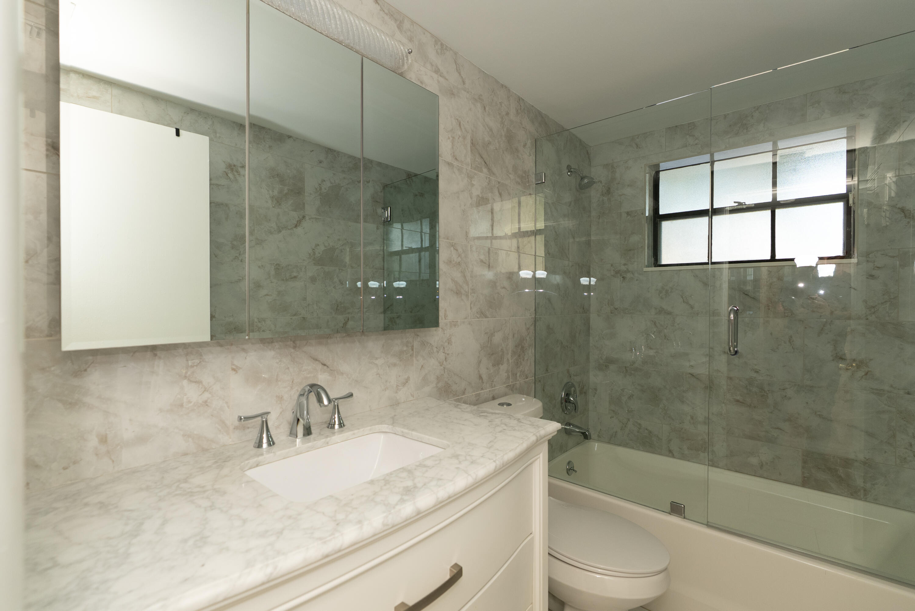 300 Inlet Way, Unit 2 Palm Beach Shores, FL 33404 - Photo 18 of 18 a bathroom with a granite countertop sink toilet and shower