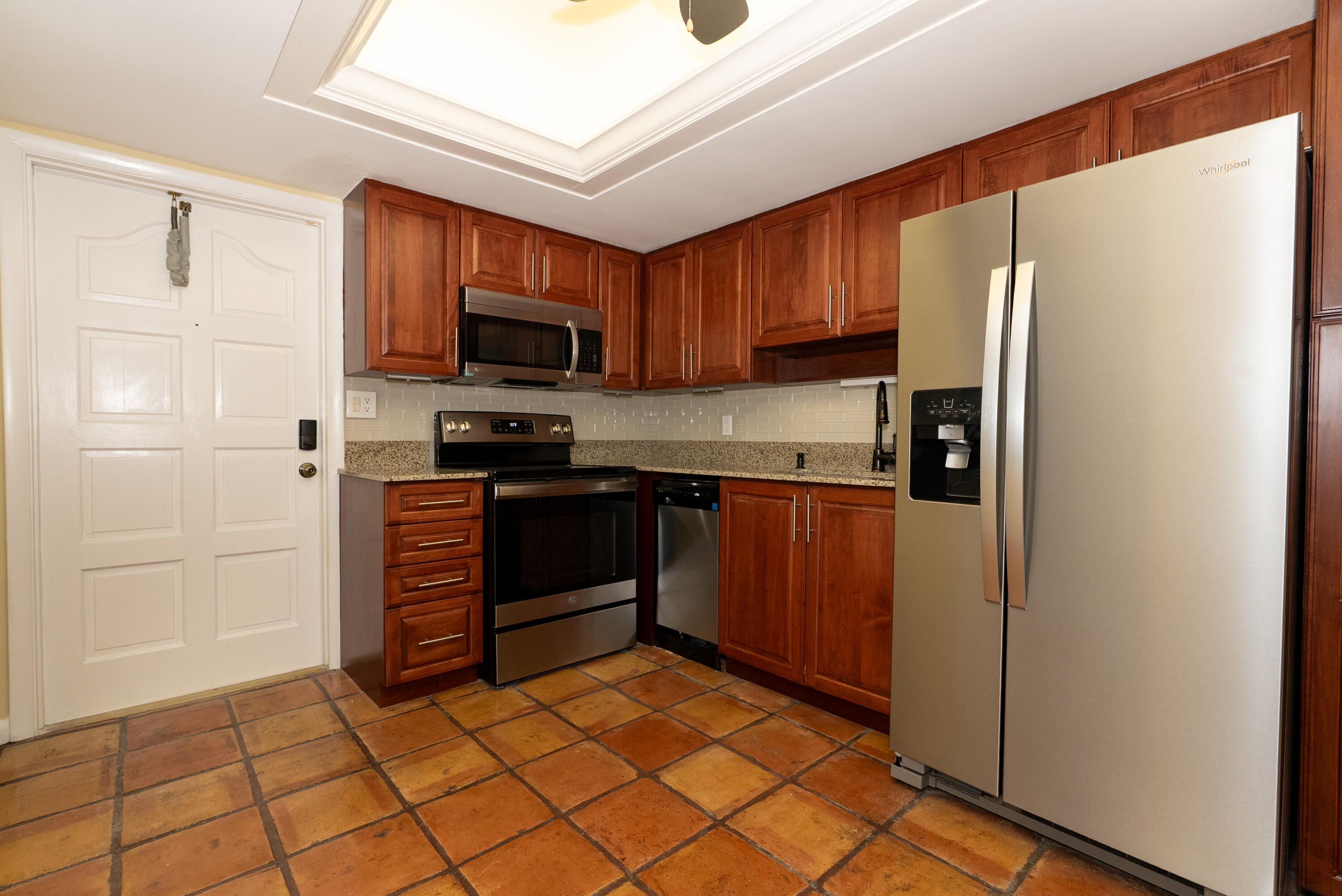 300 Inlet Way, Unit 2 Palm Beach Shores, FL 33404 - Photo 3 of 18 a kitchen with stainless steel appliances granite countertop a refrigerator and a stove top oven