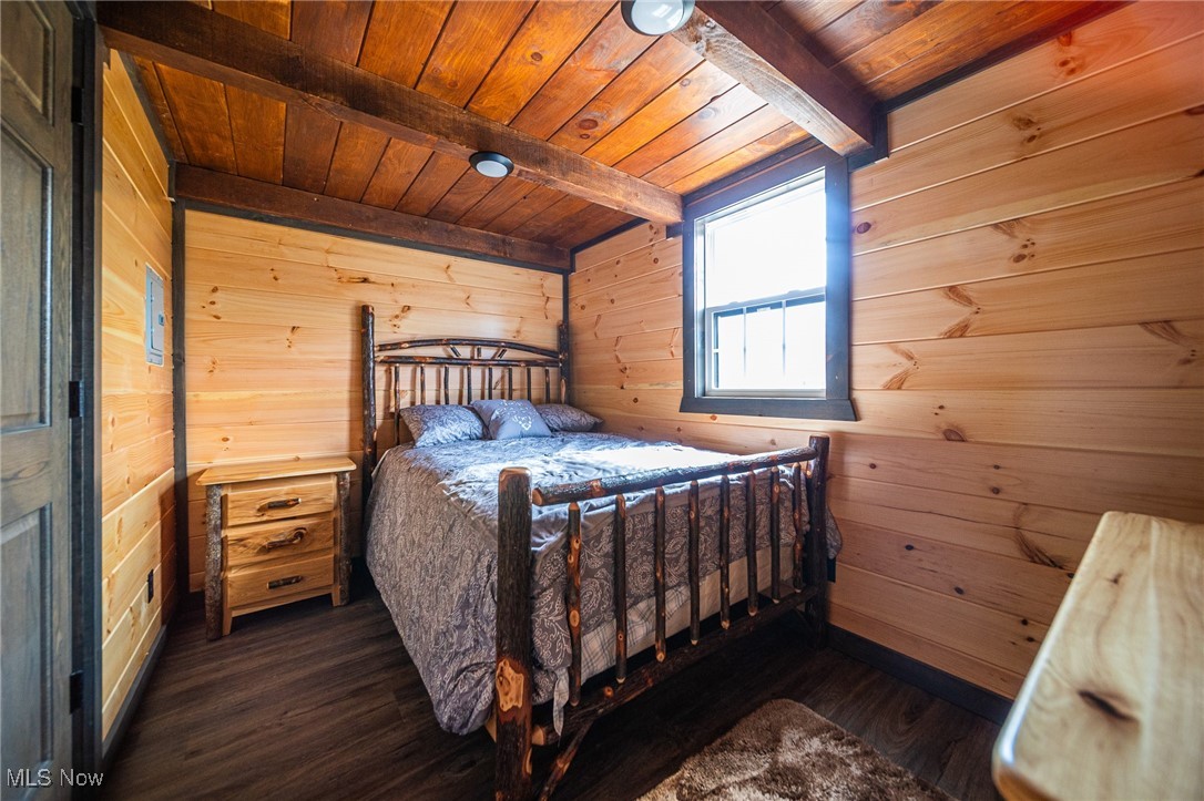 State Road Kingsville, OH 44048 - Photo 6 of 38 Bedroom with wooden walls, beam ceiling, dark wood-style floors, and wood ceiling