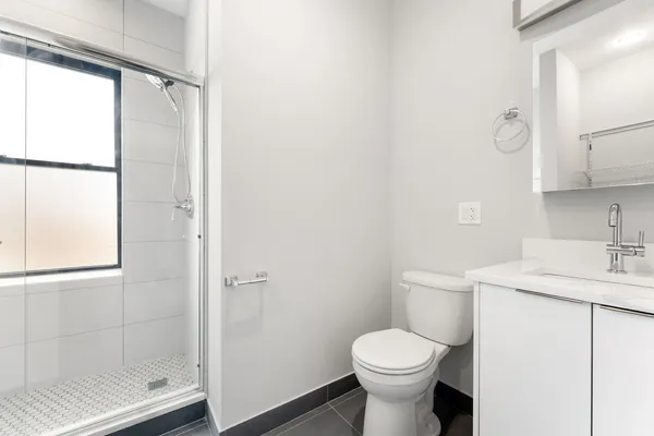 a bathroom with a sink toilet and shower