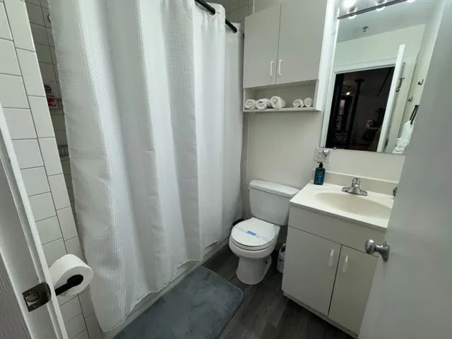 a bathroom with a sink toilet and shower