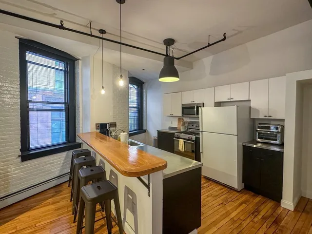 a kitchen with refrigerator and windows