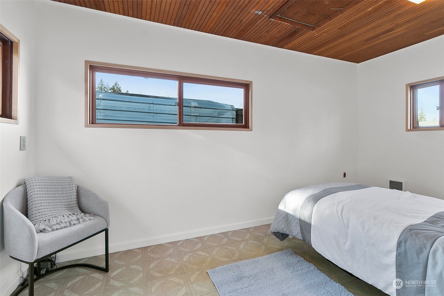 21650 Sweeney Road Southeast Maple Valley, WA 98038 - Photo 23 of 36 a bedroom with a bed and a couch