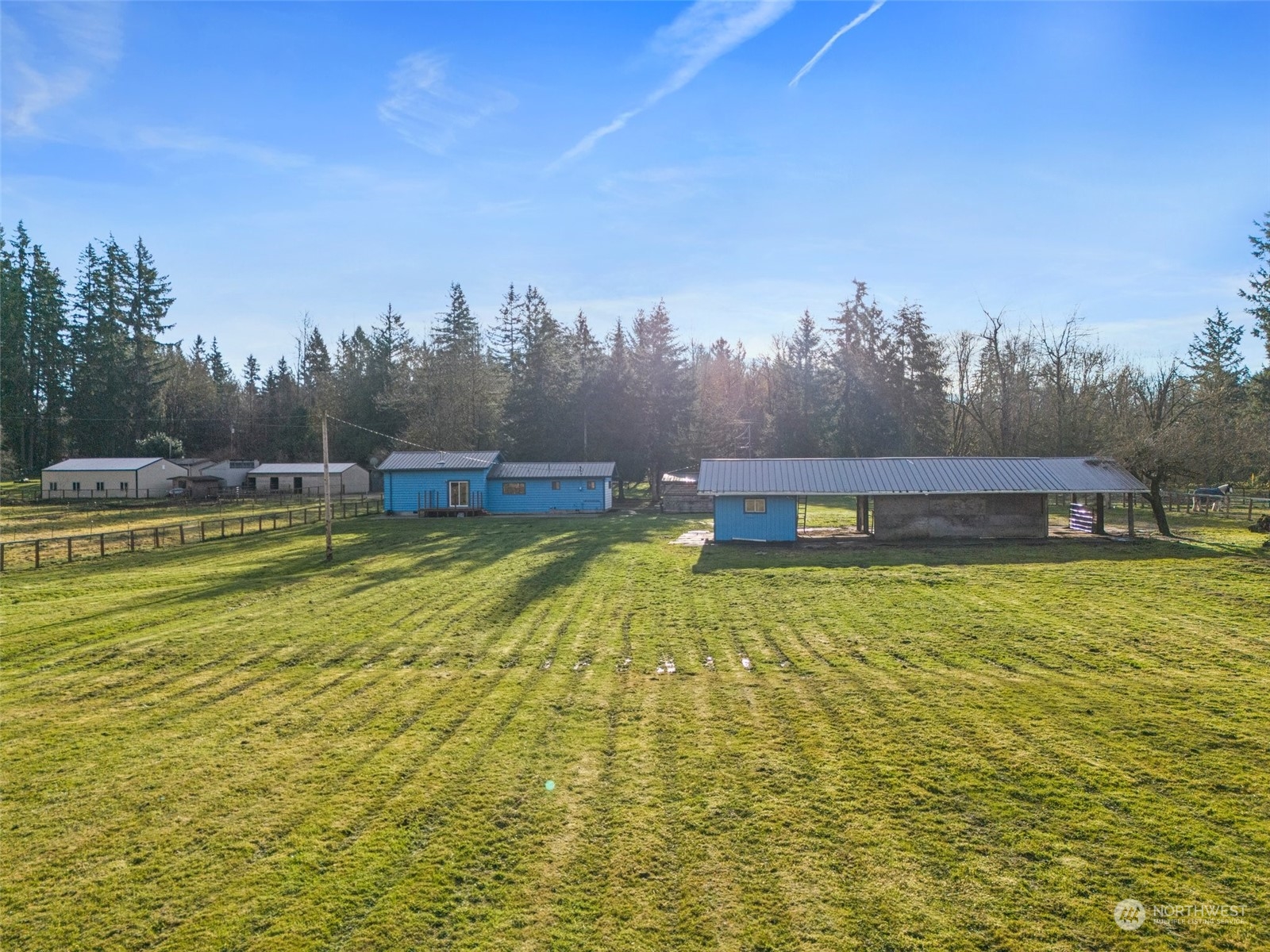 21650 Sweeney Road Southeast Maple Valley, WA 98038 - Photo 5 of 36 a view of a swimming pool with an ocean and trees in the background